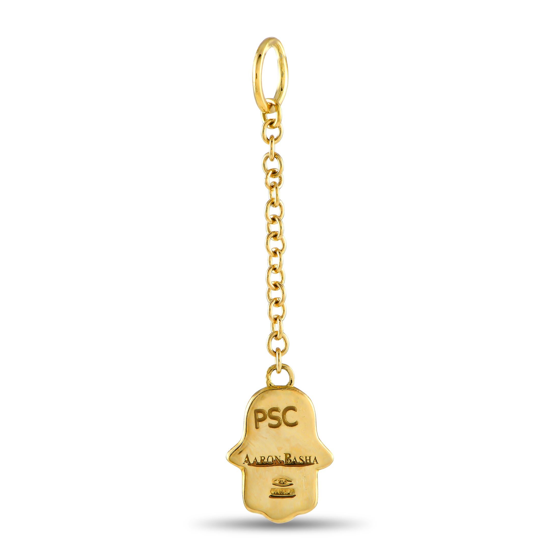 This Aaron Basha pendant features the iconic Hamsa symbol a palm-shaped amulet that is said to promote positivity and prosperity for all who wear it. White enamel contrasts beautifully against the opulent 18K Yellow Gold, while a singular inset