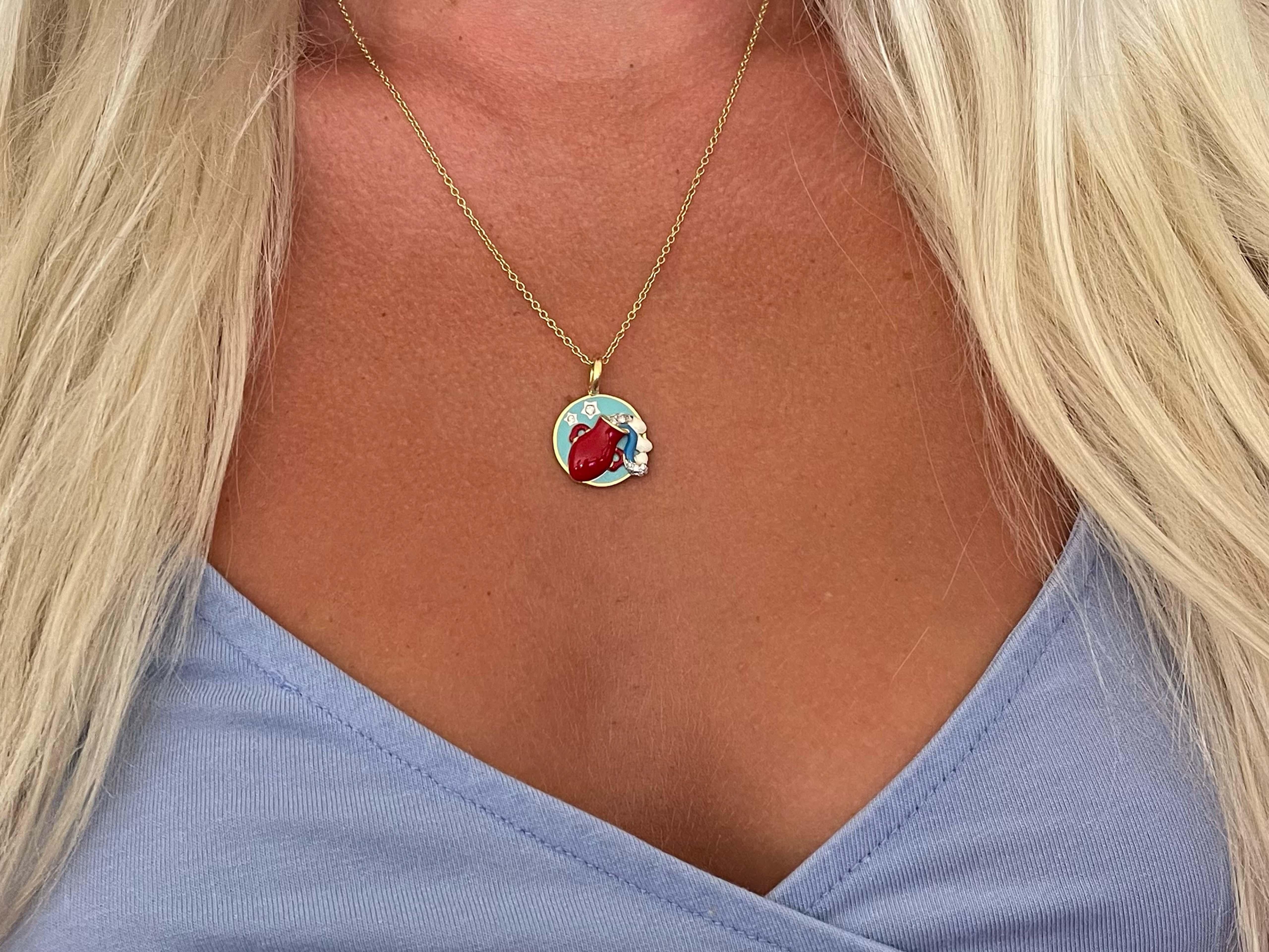 This beautiful aquarius diamond Horoscope pendant features a water carrier, symbolic with the aquarius zodiac sign. The enamel is red, seafoam blue and dark blue. This pendant and chain is crafted in 18k yellow gold. The diamonds on the pendant are