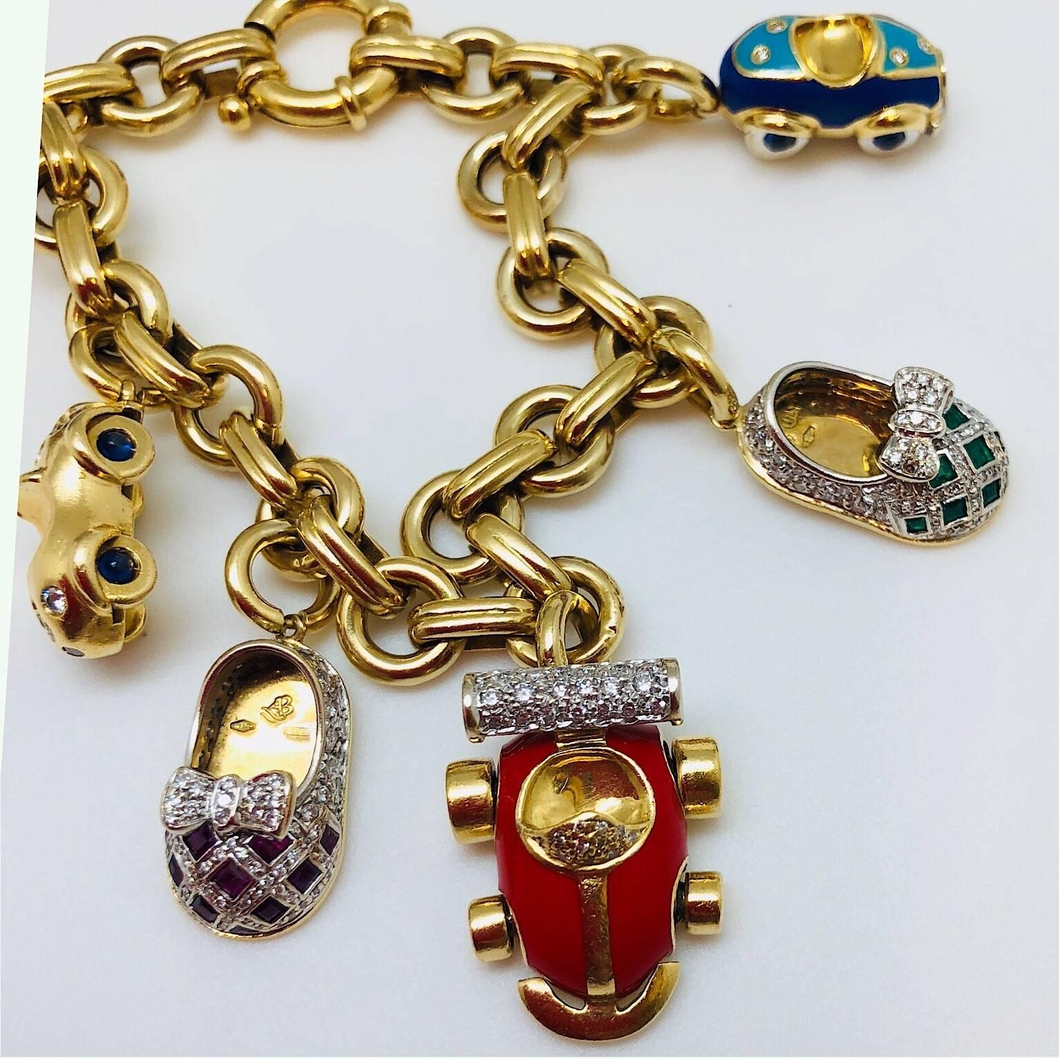 This 18KT Yellow Gold Charm Bracelet. Has 6 Charms.
Four cars with one Ruby Diamond Baby Shoe and one Emerald Diamond baby shoe.
Charms:
18KT Square cut Ruby Shoe Charm, Ruby = 1.27 carats Dia. Bow = .65 Carat
18KT Emerald Square cut Shoe Charm,