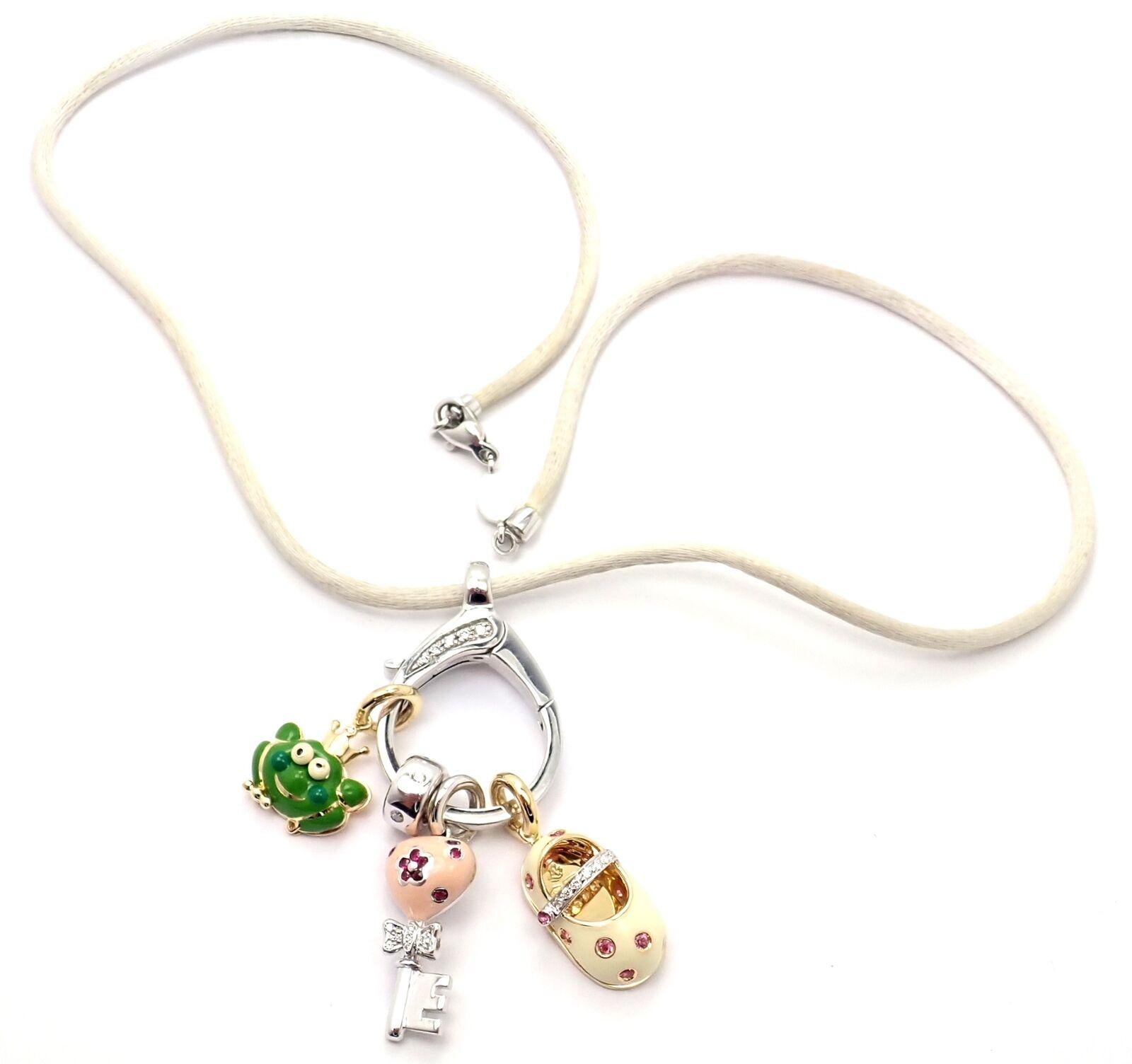 18k White Gold Diamond Oval Pendant Enhancer on A Silk Cord With 3 Charms and 1 Spacer by Aaron Basha. 
With 1. Baby Shoe
2. Frog
3. Key
Round brilliant cut diamonds VS1 clarity, G color total weight approx. .25ct
Details: 
Length: White Silk Cord: