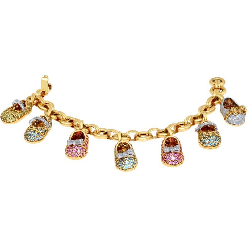 Vintage Aaron Basha bracelet with 7 diamonds & colored semi precious Baby Shoe Charms, in 18k yellow gold. 7.00 inches long.