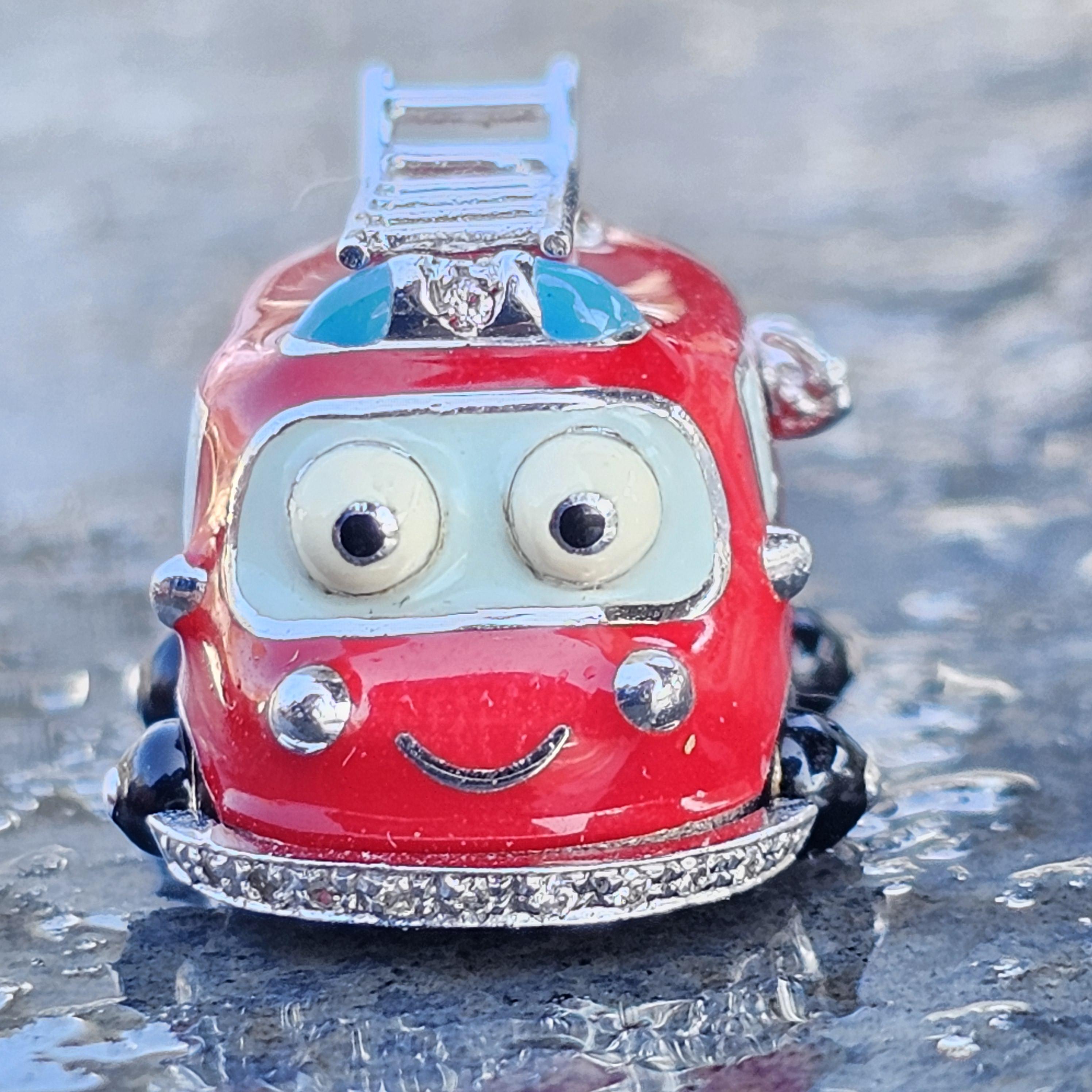 Enhance your charm collection with this delightful Aaron Basha creation. This whimsical charm features a playful red enamelfiretruck design, complete with expressive eyes and a friendly smile. Crafted from high-quality 18k gold and white gold, it is