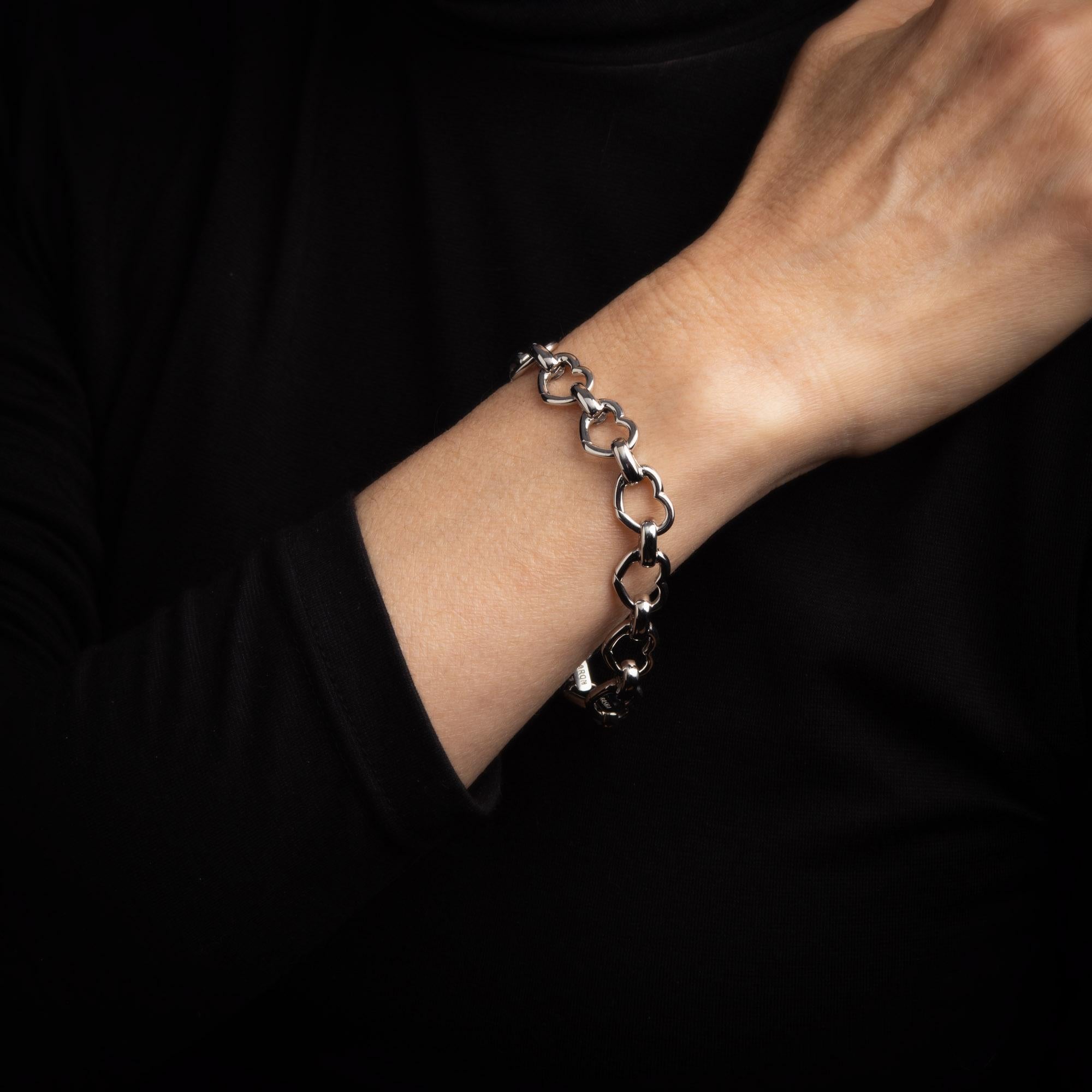 Stylish and finely detailed Aaron Basha bracelet crafted in 18k white gold. 

The bracelet makes a great statement on the wrist. Each of the heart links features an invisible slip closure that allows for the addition of charms to every link if