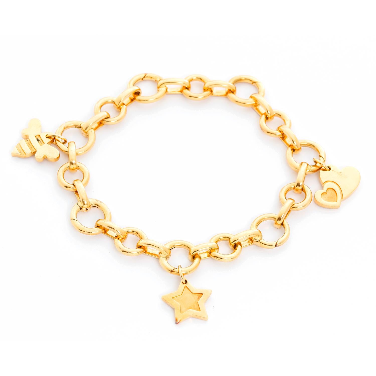 Aaron Basha Open Link Charm Bracelet with Tiffany & Co. Charms - 18K Yellow Gold Bracelet with small open links ( 7 ) for charms. Wrist size 6 3/4 inches. Total weight 24.4 grams. Hallmarked on each link AAron Basha. Includes three Tiffany & Co.