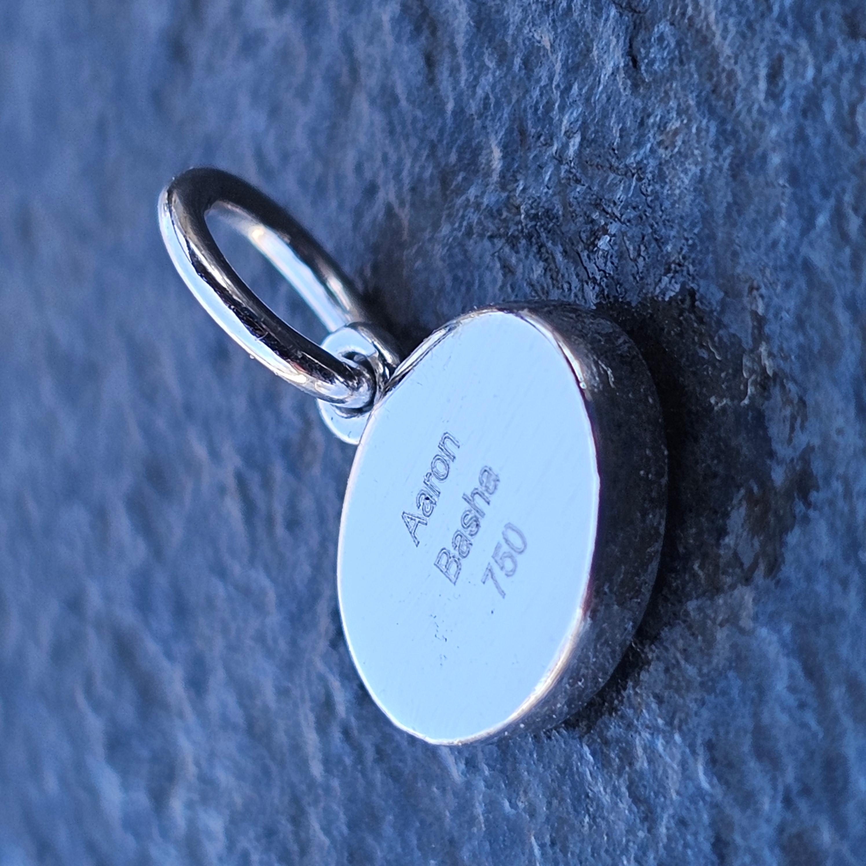 This Aaron Basha charm is a captivating piece. Crafted with precision, it features a striking design with a blue and white enamel eye motif. The charm is made from high-quality 18k gold, adding a touch of luxury to its appearance. The charm is very