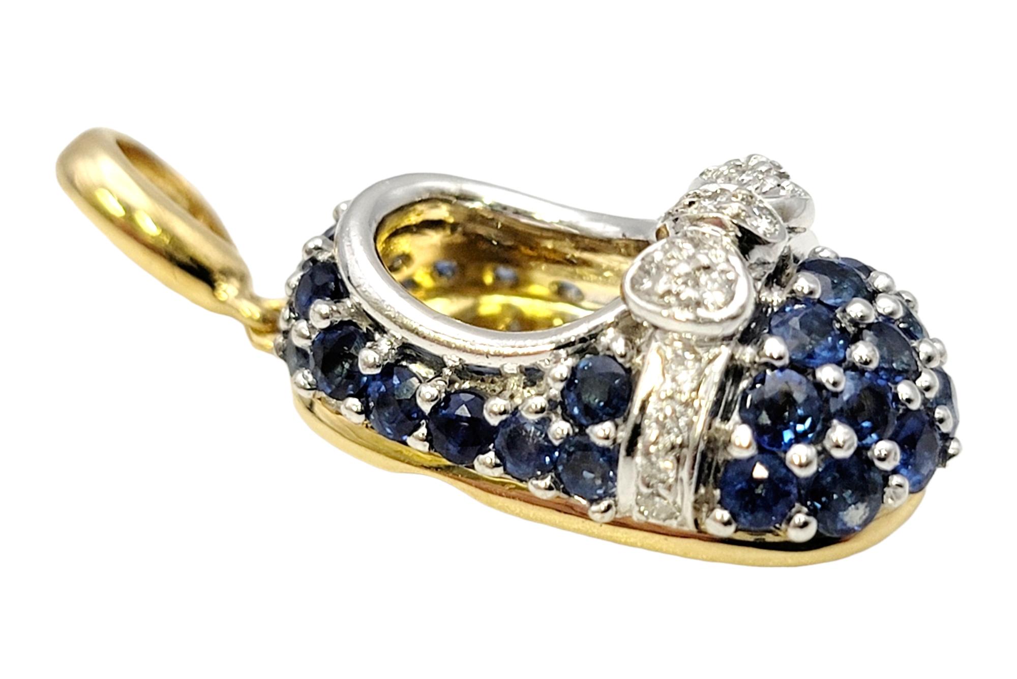This charming pendant by Aaron Basha will add an elegant yet playful touch to your look. Embellished with natural blue sapphires and a white diamond bow, this sparkling baby shoe pendant / charm is the perfect memento to add to your favorite