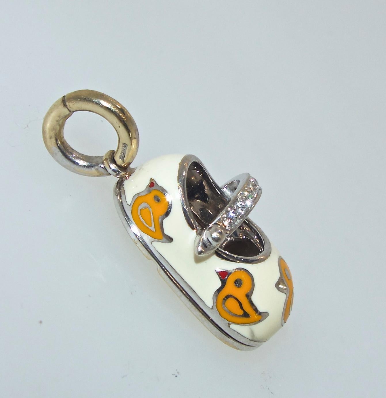 New condition, probably not worn, this pendant is yellow enamel of small ducks and decorated with white (H,VS1) diamonds, the baby shoe is one inch by .5 inches.  We will provide either an yellow or white gold 14K 16 inch. chain