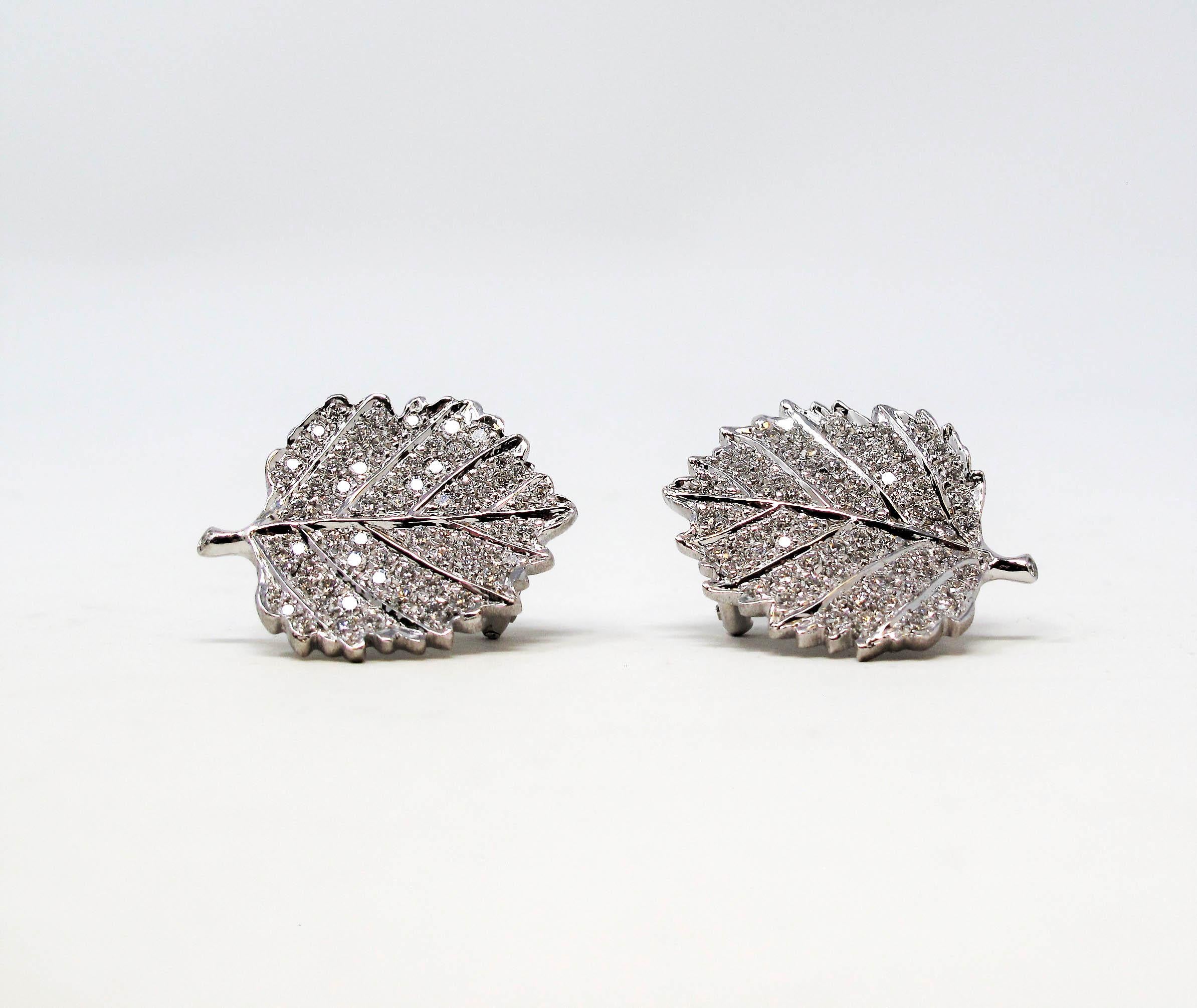 Stunningly sparkly pave diamond and 18 karat gold leaf earrings. These elegant botanical earrings are wonderfully detailed with exquisite craftsmanship. The glittering diamonds really elevate the pair, allowing them to truly radiate on the ear. 