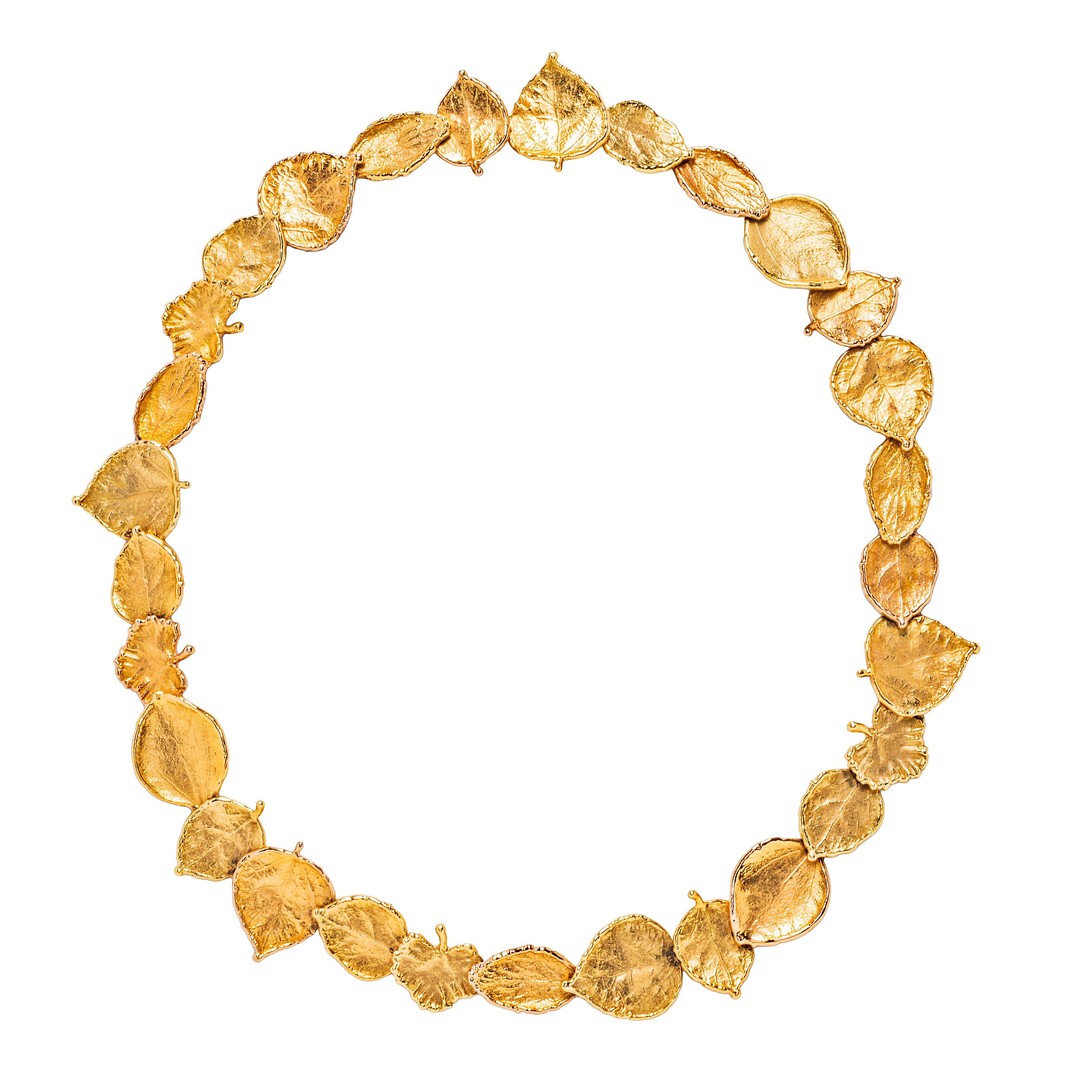 Comprising a necklace set with a series of links in the form of 19k and 18k yellow gold leaves of varying shapes, with ‘AH’ maker’s mark; and a pair of earrings of similar design, with diamond-set stems, set in 18k yellow gold and platinum, signed