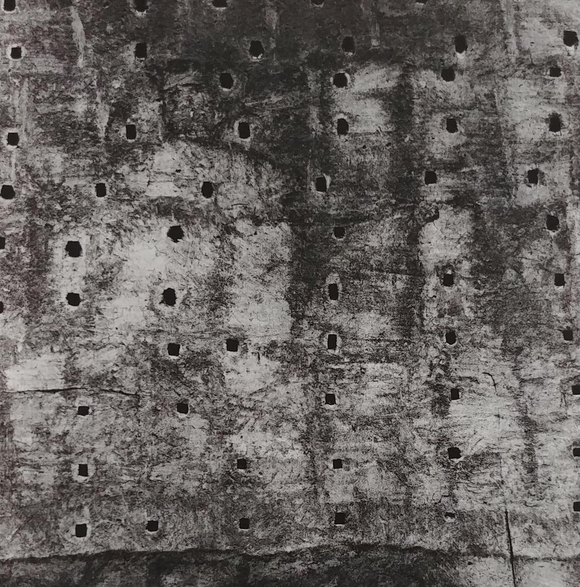 Morocco 93 by Aaron Siskind presents an abstract image, a close up of a textured rock slab. Small dark square holes scatter across the rock. The subject is cropped, emphasizing the textures of the material. 

Morocco 93 by Aaron Siskind is listed as