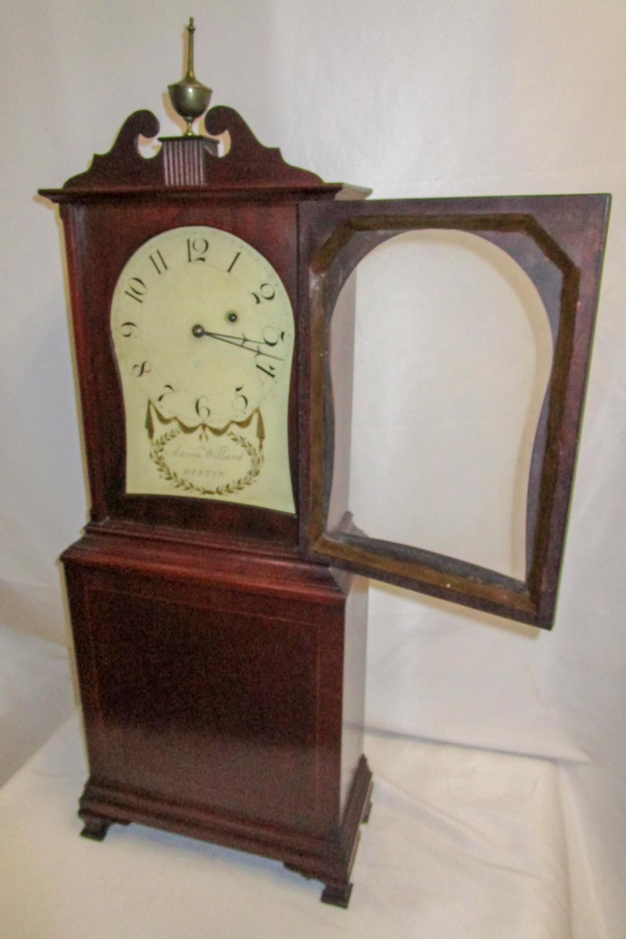 This magnificent shelf clock has an arched and inlaid pediment over a painted dial that is signed 