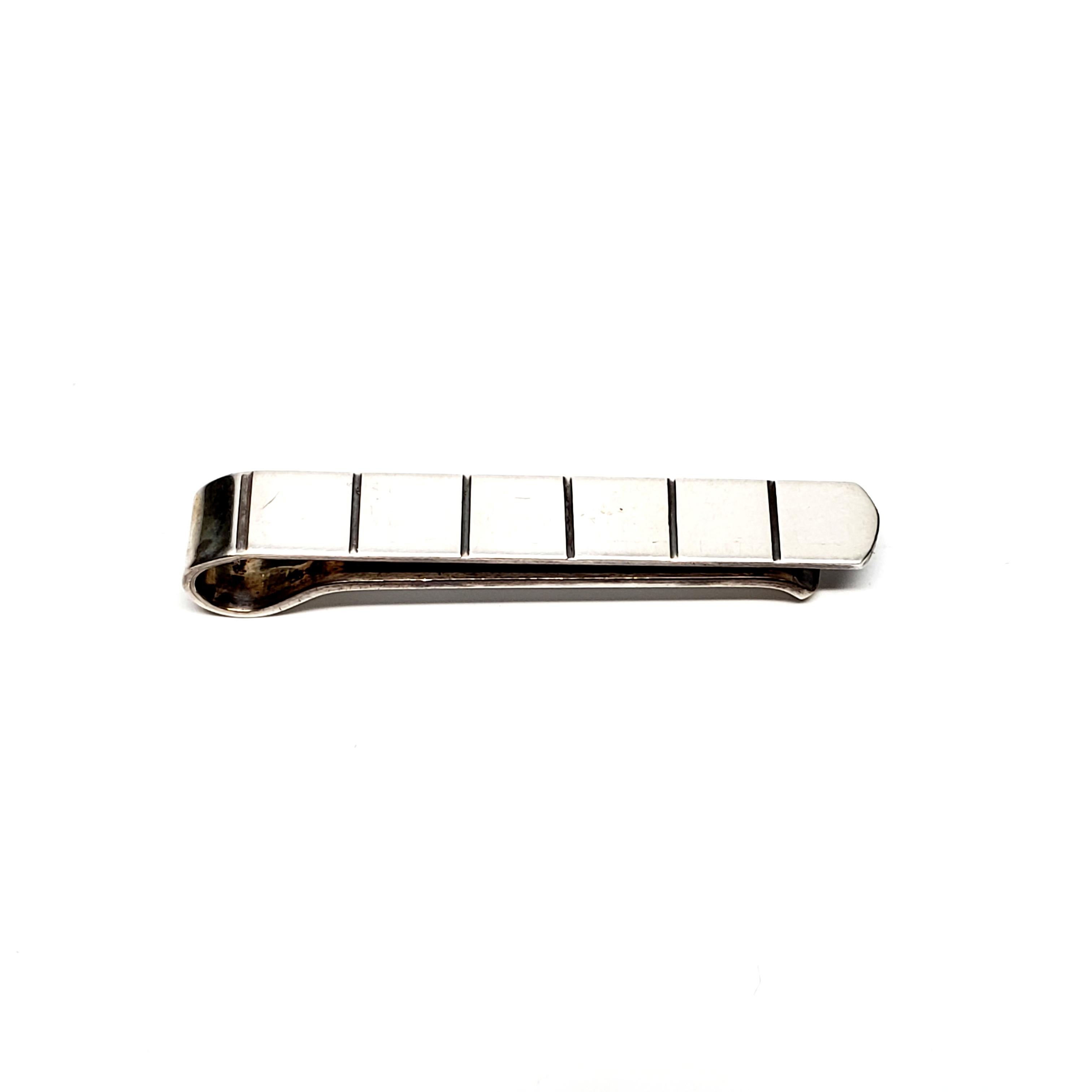Vintage sterling silver tie clip and cuff links by Aarre & Krogh of Randers, Denmark, 1949-1990.

This set of modernist grooved design is in A&K's distinctive style that is popular with collectors.

Tie clip measures 1 3/4