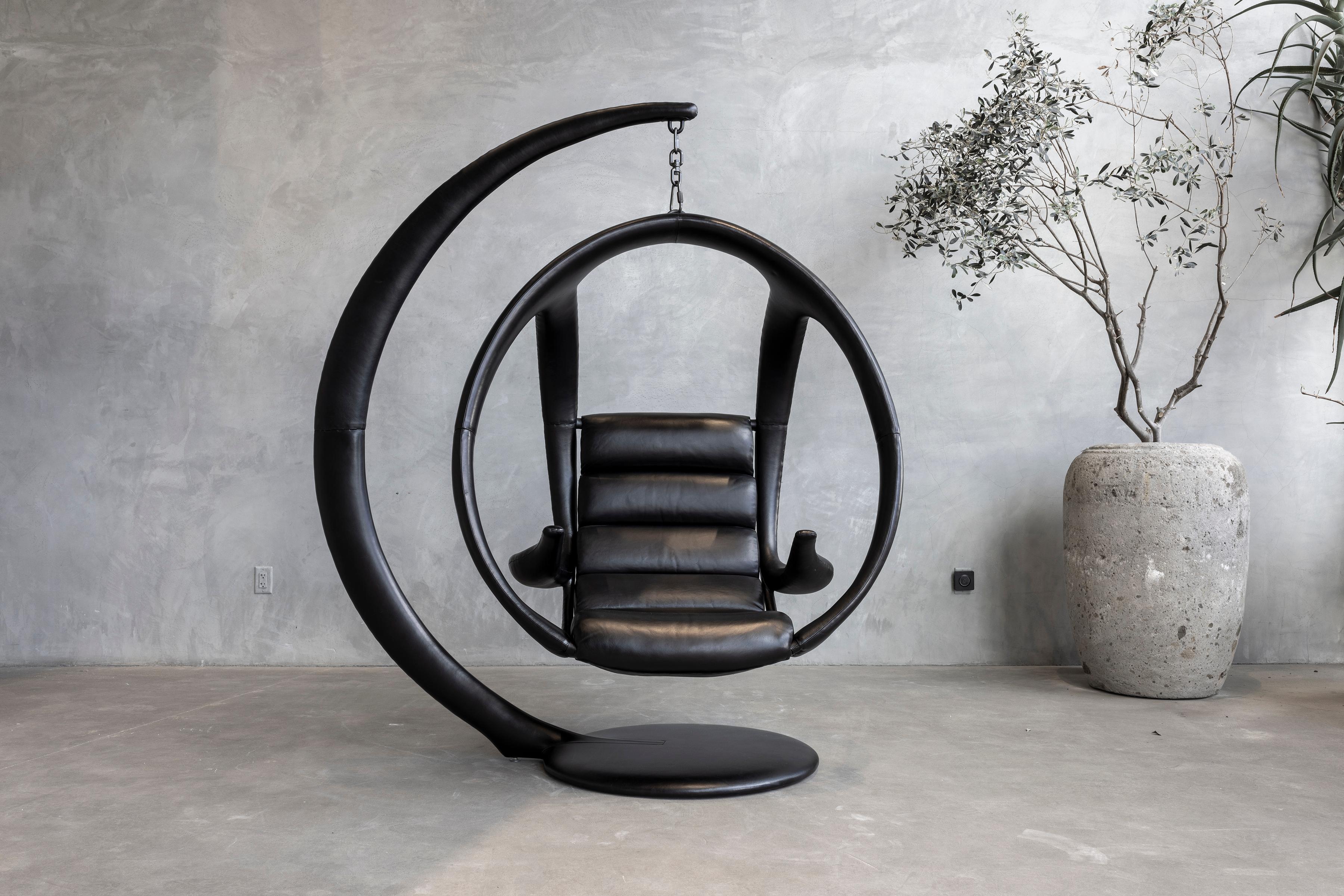 Ab Ovo Hanging Pod Chair by William Emmerson
Limited Edition Of 3 Pieces.
Dimensions: D 99.06 x W 167.64 x H 208.28 cm. SH: 45.72.
Materials: Brass and black leather.

Limited edition of 3 pieces, only 1 remaining. Available in black or brown