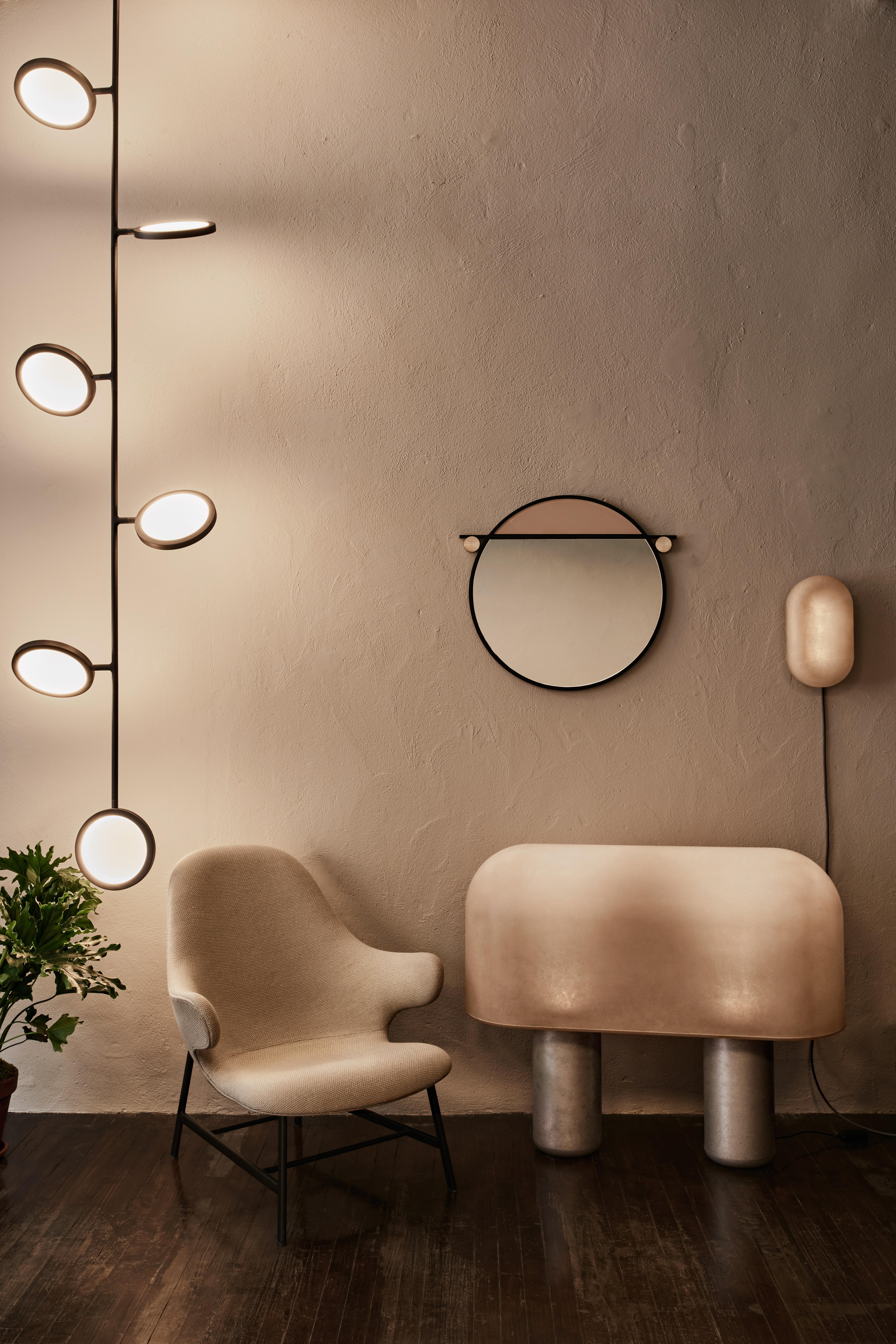 The Abal mirror collection consists of three simple geometries- round, capsule and rectangle. Made in a range of sizes, each mirror is visually segmented by a metal frame dividing the mirror from a panel of painted glass.
 