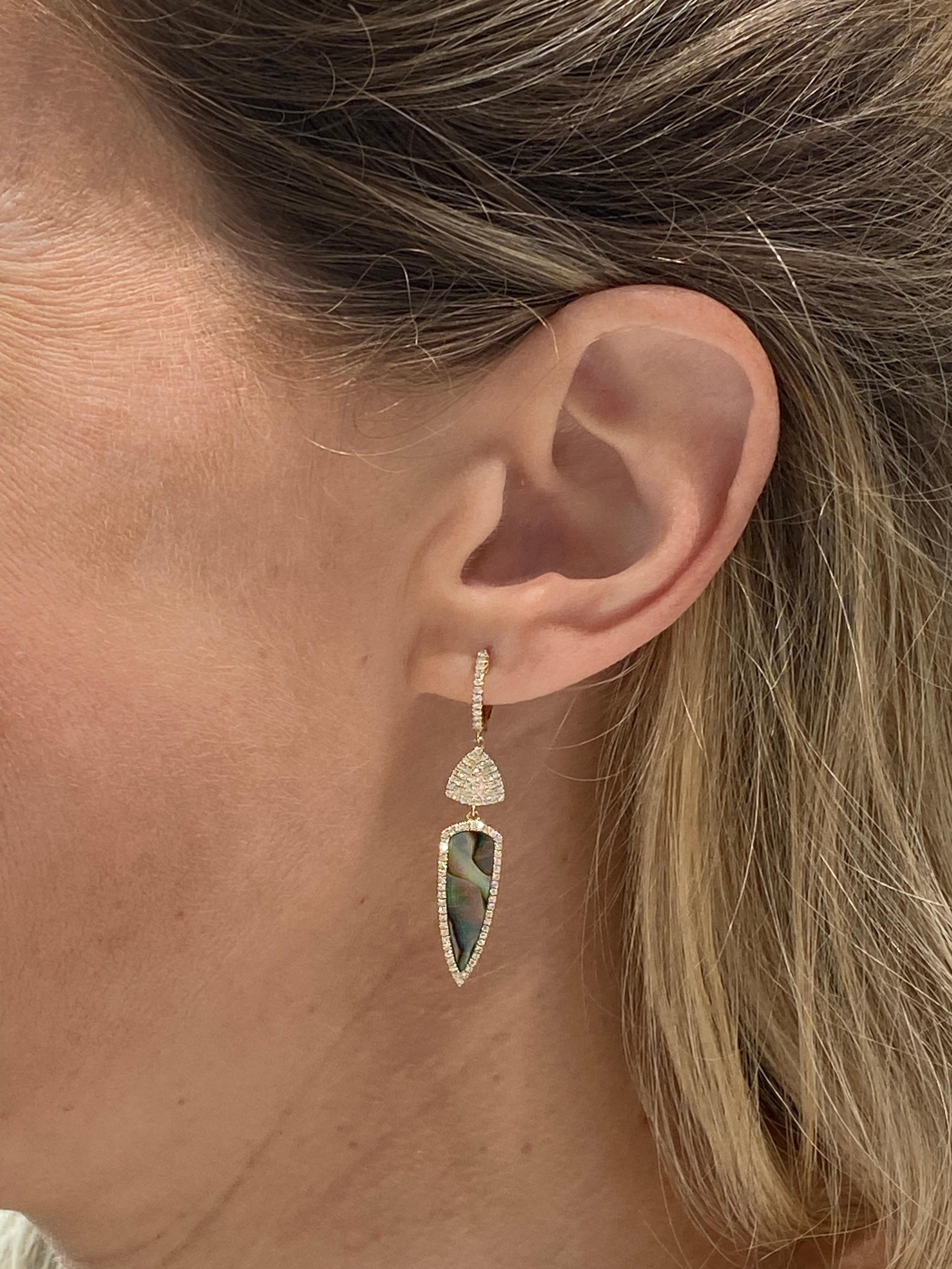 These unique earrings feature an arrow shaped abalone shell that dangles from a huggie hoop earring accented with 0.46 carat total weight in natural, round diamonds. 
Measurements:  Huggie Height: 11mm / Pave Triange Height: 7.5mm / Halo Triangle