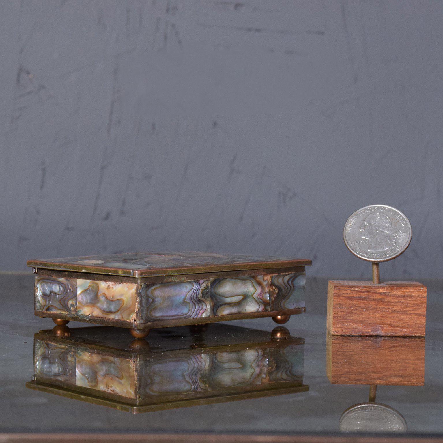For your consideration a vintage box made on bras with interior section in rosewood covered with abalone. 
Stamped underneath: 