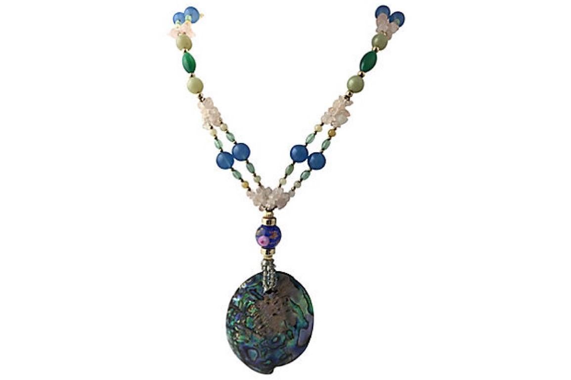 Statement necklace featuring a large centrally set abalone shell on a multi-strand chain of art glass, glass, and quartz beads with 12K gold-filled accents and jump ring clasp. Abalone shell, 2