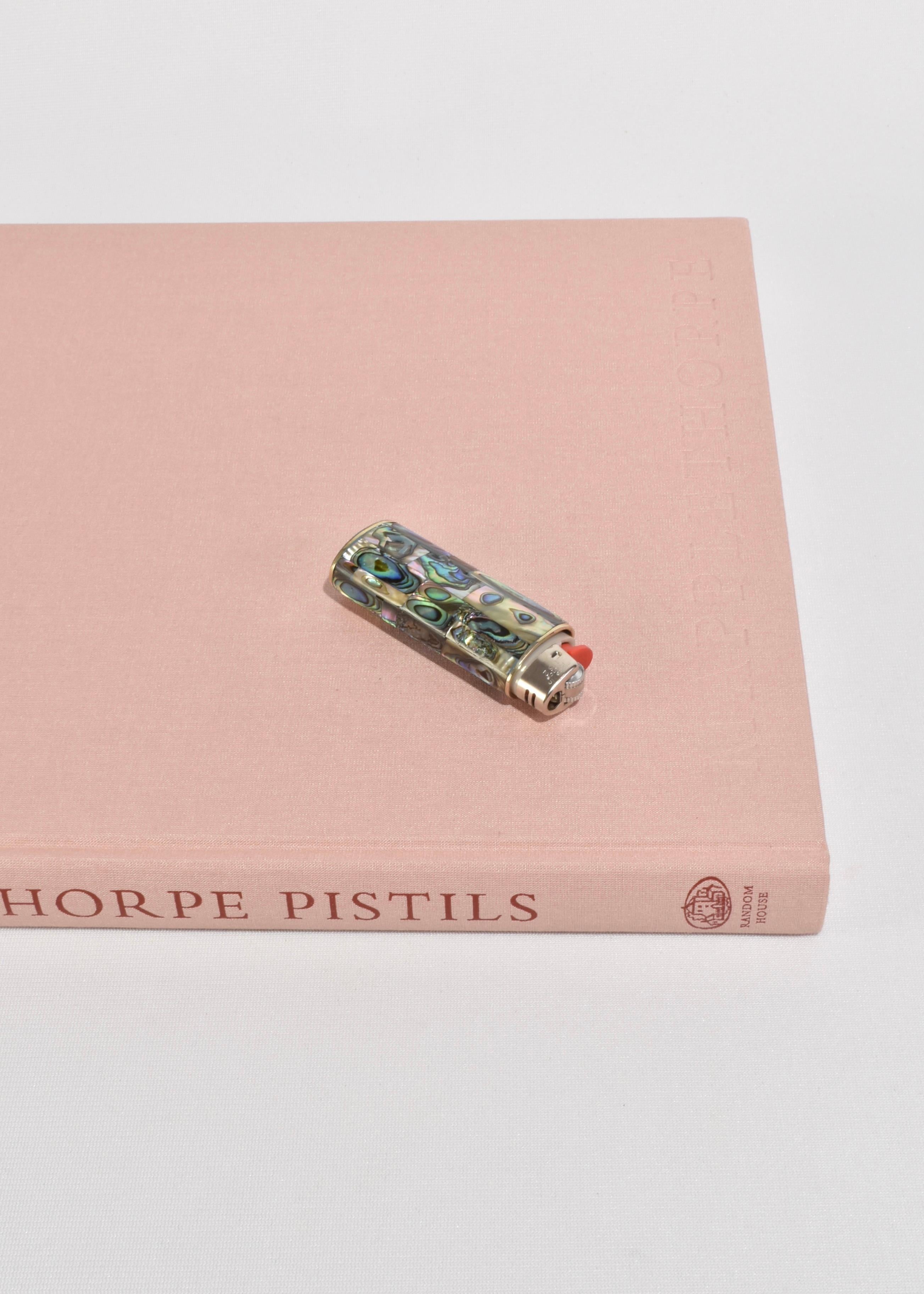 Abalone lighter case with alpaca silver detail. 

Fits a Bic Classic lighter, not included.