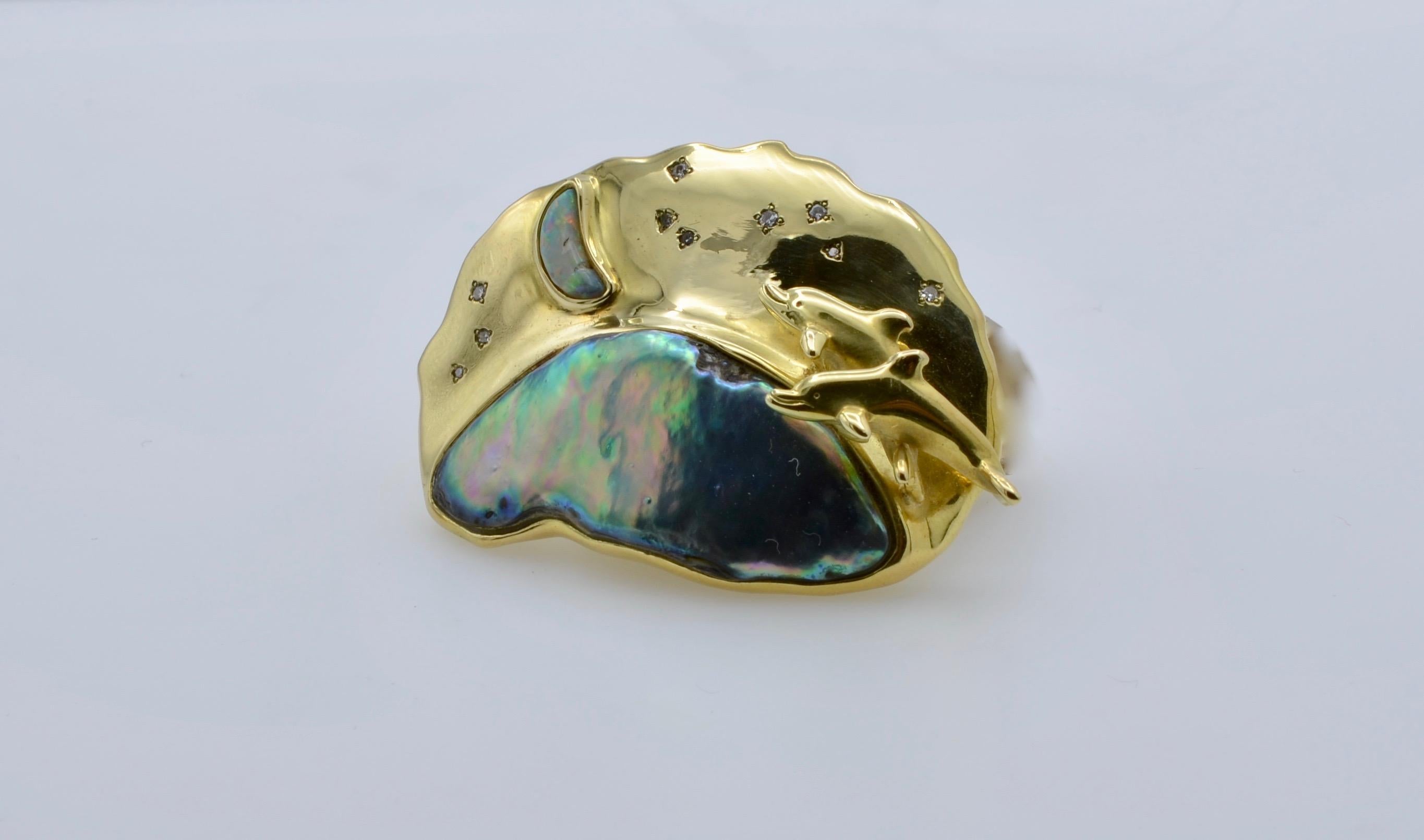 This stunning pendant is not for the faint of heart. It is bold and dramatic. The dolphins are jumping over an 'abalone wave' in search of the 'opal moon' and shimmering 'diamond stars'. This unique piece of jewelry tells a story of 'life aquatic'