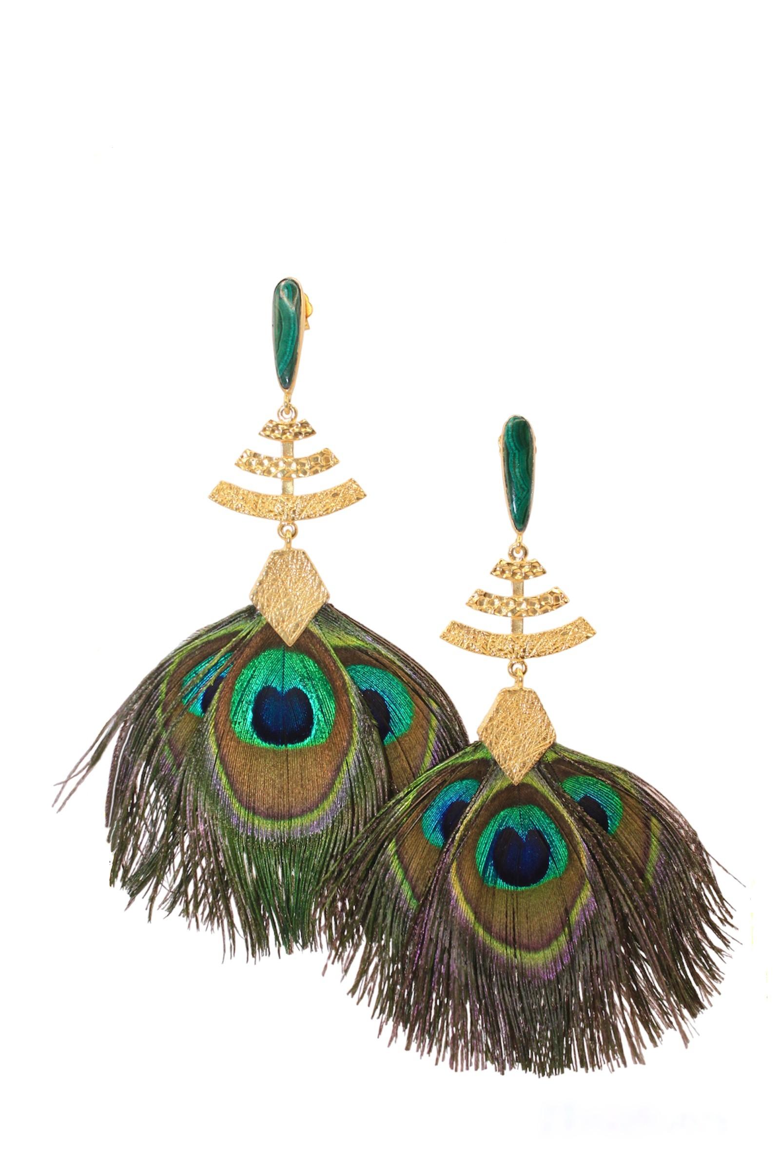 This Made to Order Abanico Earrings are inspired by the splendor of Pre-Columbian art. These remarkable earrings harmoniously blend 14k yellow gold vibrant peacock feathers, and seductive malachite stones, creating a unique and captivating timeless