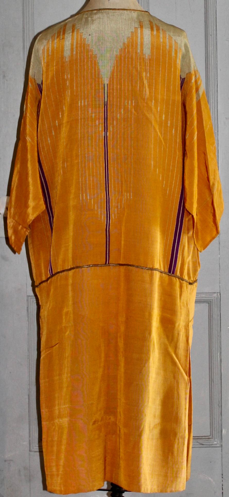As a dress in the manner of Poiret. Silk with gold thread. Slit tapestry technique. Tablet Weaving.