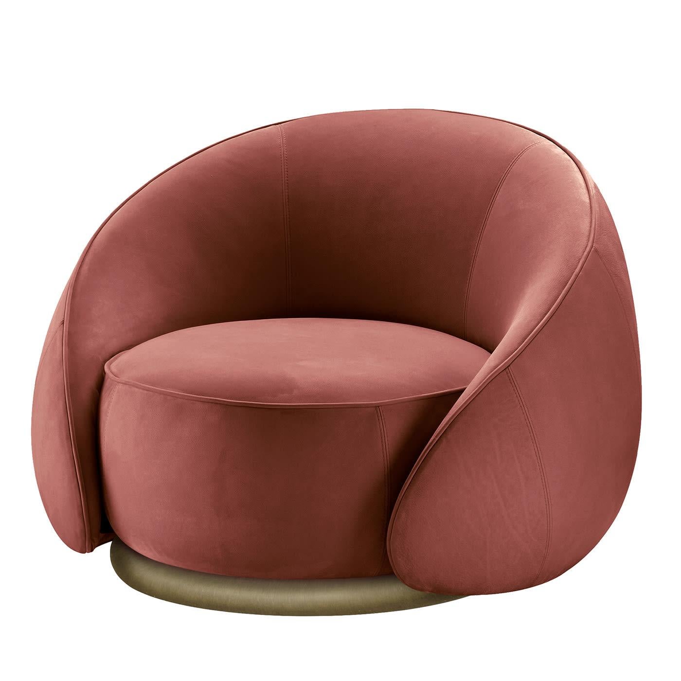 The comforting feeling of an hug inspired the enveloping silhouette of this plush armchair, marked by a curved shell with sloping sides that shares with the cylindrical seat the same plump padding. Luxuriously covered in red-hued leather for a