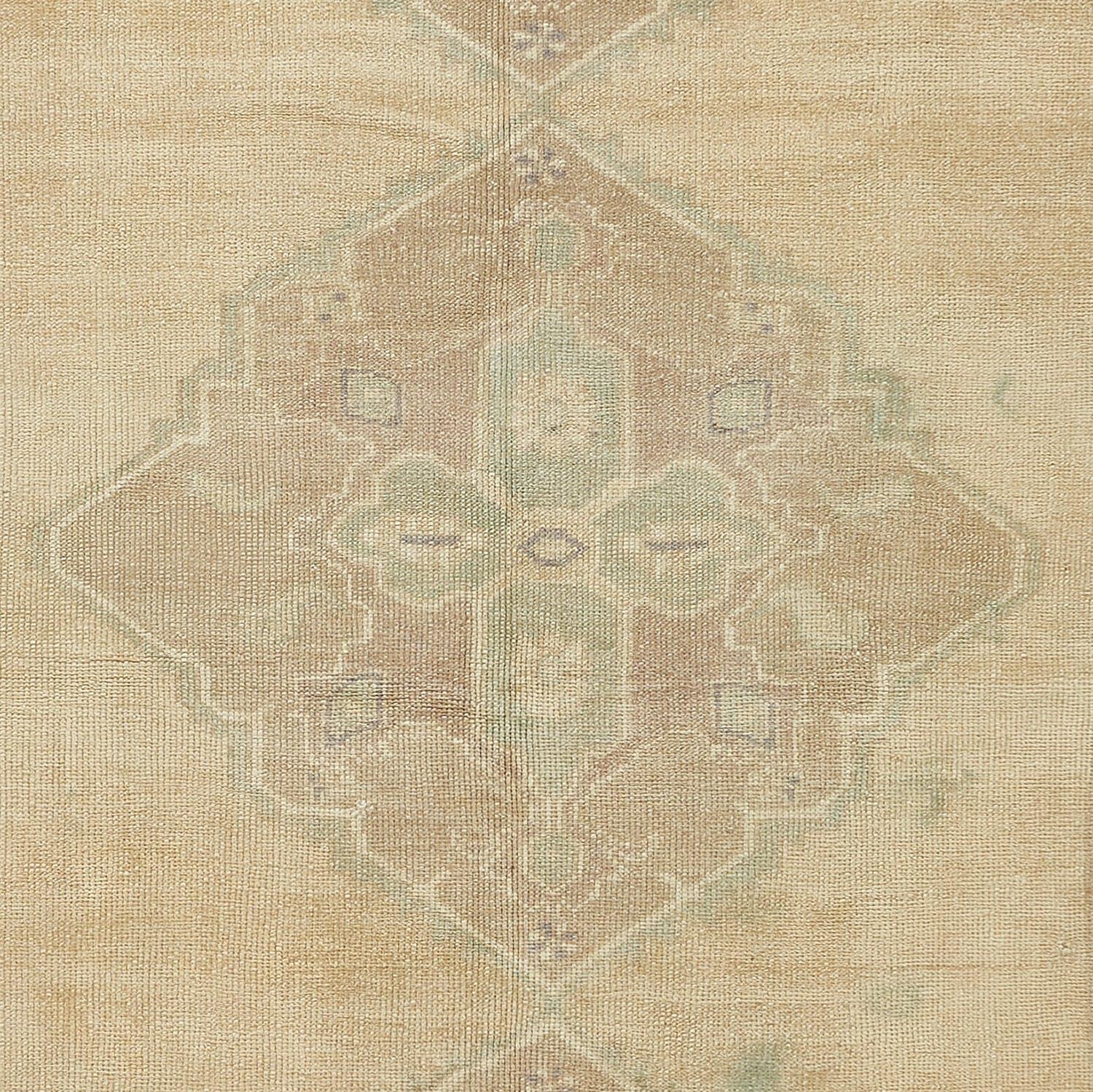 This vintage wool rug from Turkey is sun-faded and sheared, revealing faint traces of ornate traditional motifs through soft pigments. Light touches and a time-worn patina elevate this Turkish wool rug from our Fresco collection, as hints of the
