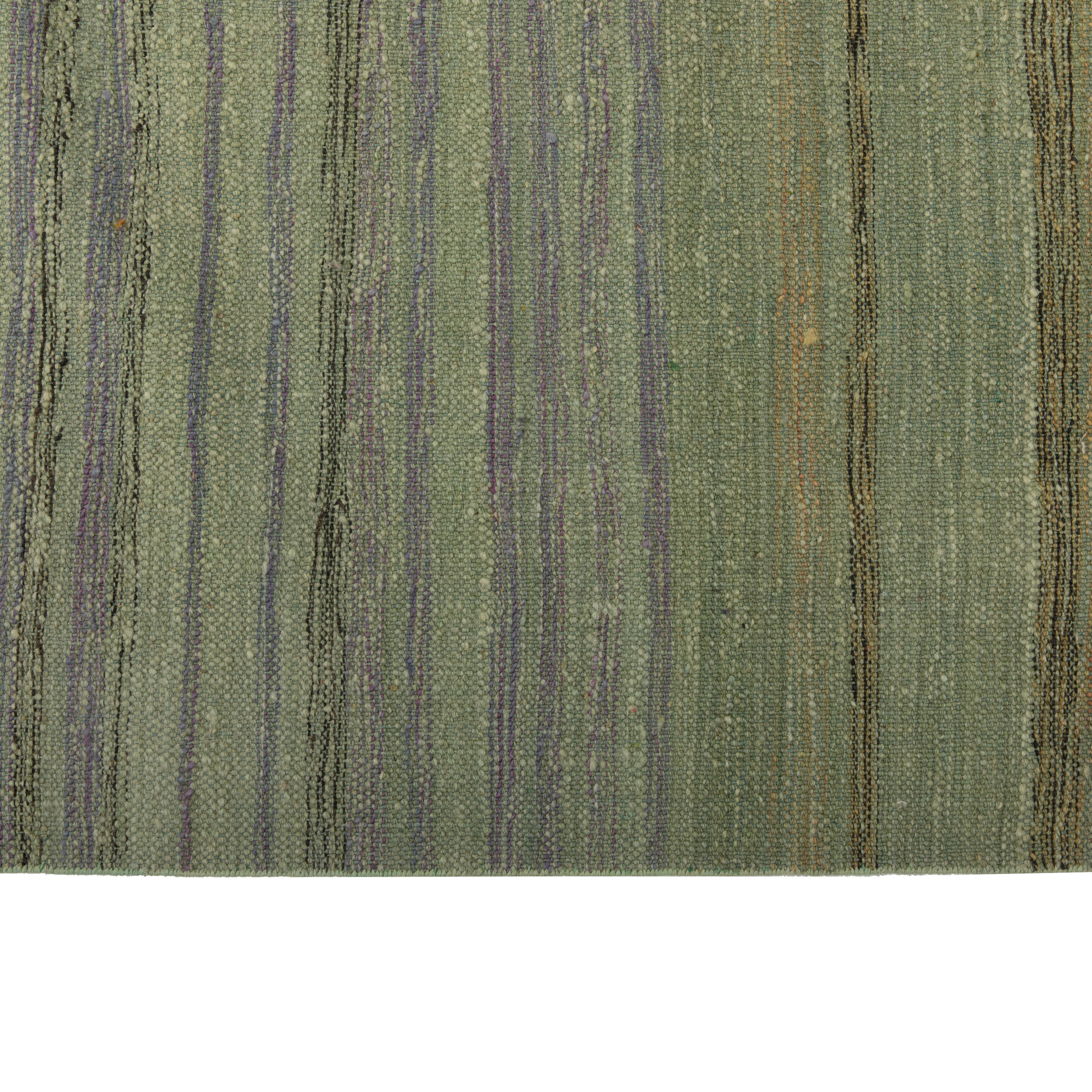 The Green Flatweave Rug - 10'11 x 13'5 is a modern, minimalist piece with a horizontal gradient pattern in shades of green. Hand-woven from high-quality wool, this flatweave rug features a soft texture and ornamental fringed edges. Perfect for