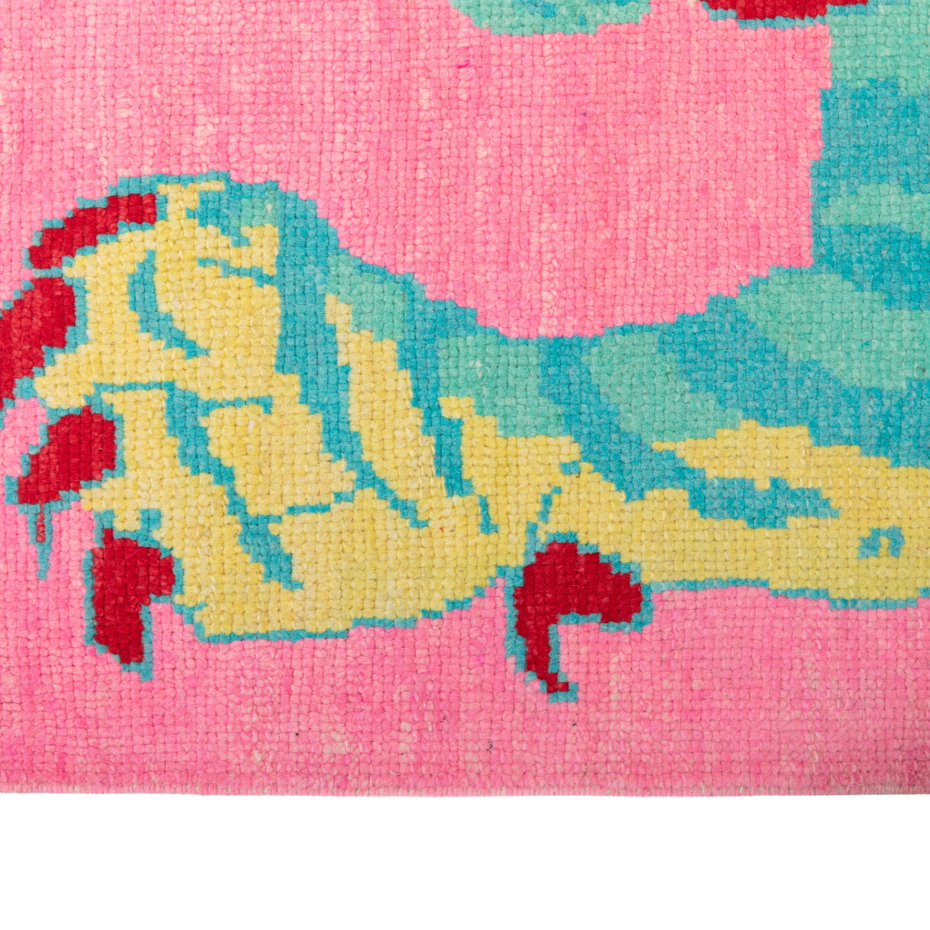 This Pink Contemporary Tiger Wool Rug features a vibrant design with a symmetrical pattern of a tiger in blue tones. The rug's modern style and high-quality hand-knotted wool construction make it a statement piece in any interior. Made in Turkey,