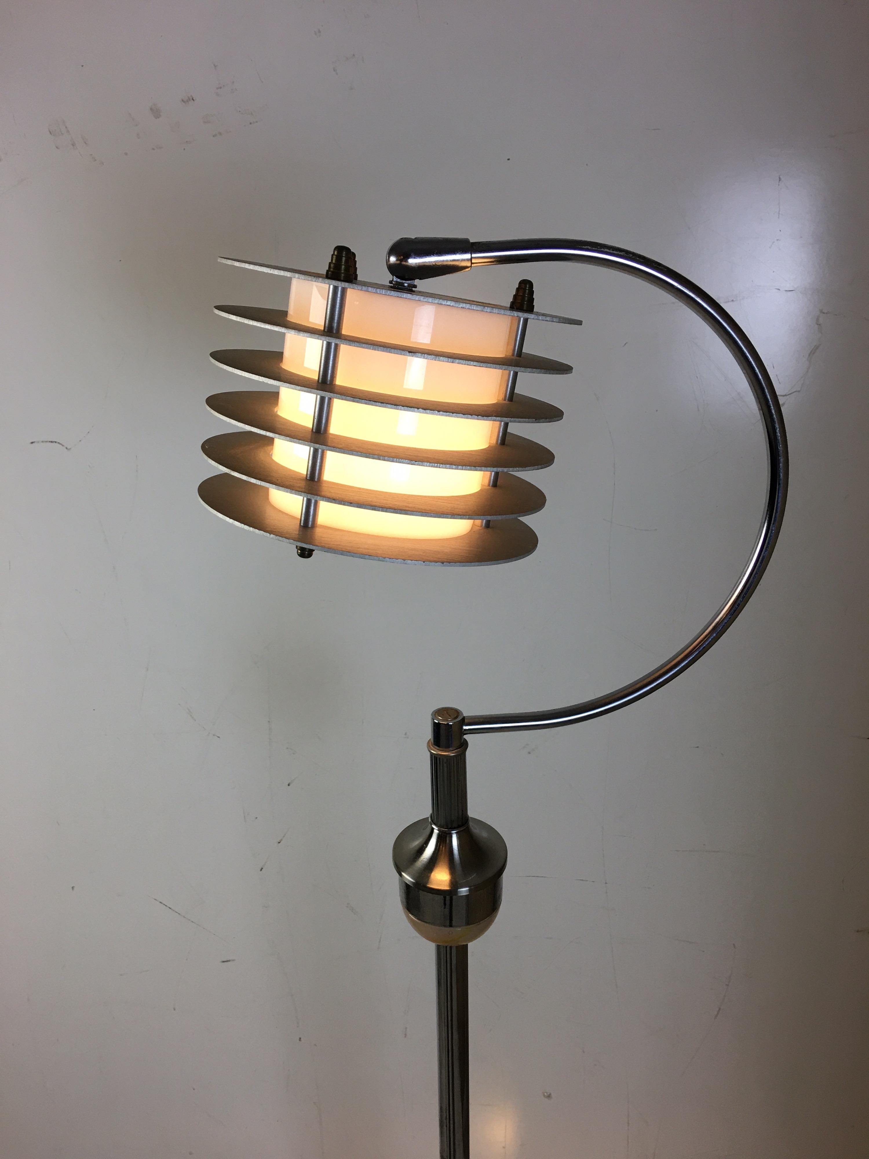 ABCO Art Deco chrome floor lamp with Light-up base. Swirled multicolored glass at bottom has it's own light source that gives this deco lamp a great twist. Lampshade moves and adjusts to point the light in many directions. Appears chrome was