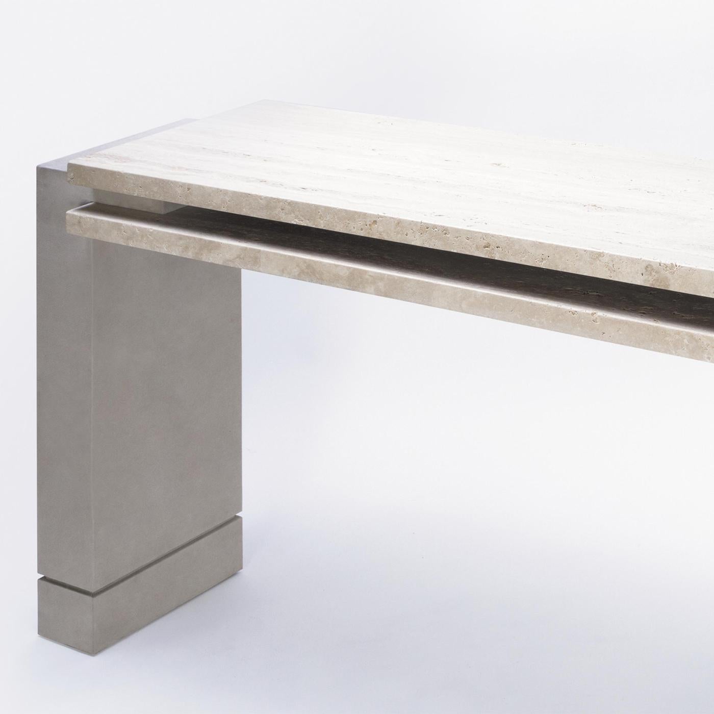 Console Table Abel Travertine with structure in solid wood, 
with travertine double tops and with feet covered with genuine 
suede leather in light grey color.