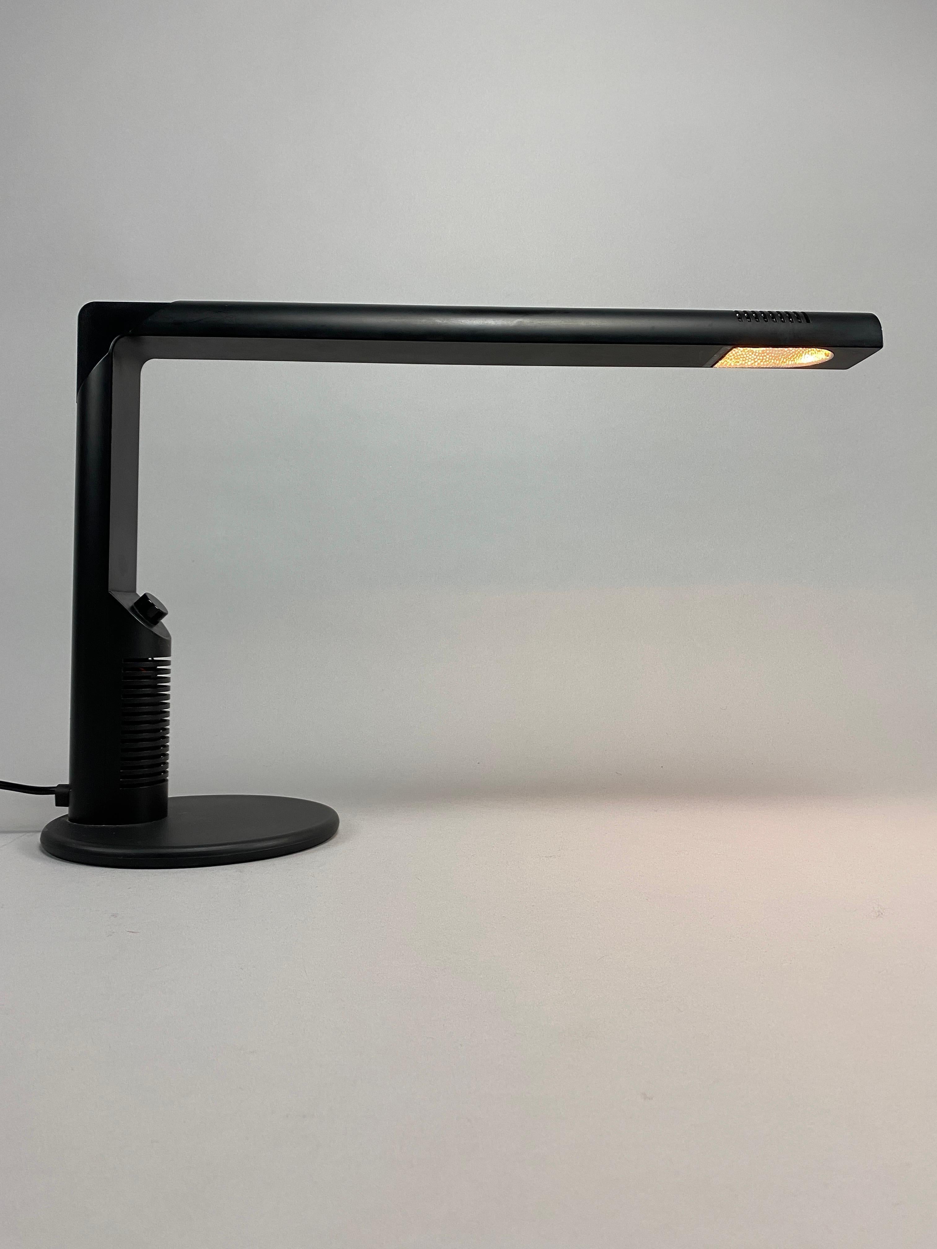 Illuminate your workspace with timeless elegance and impeccable style with the original vintage black Abele desk lamp, a masterpiece of design crafted by the renowned Gian Franco Frattini for Luci Italy. This iconic lamp not only enhances