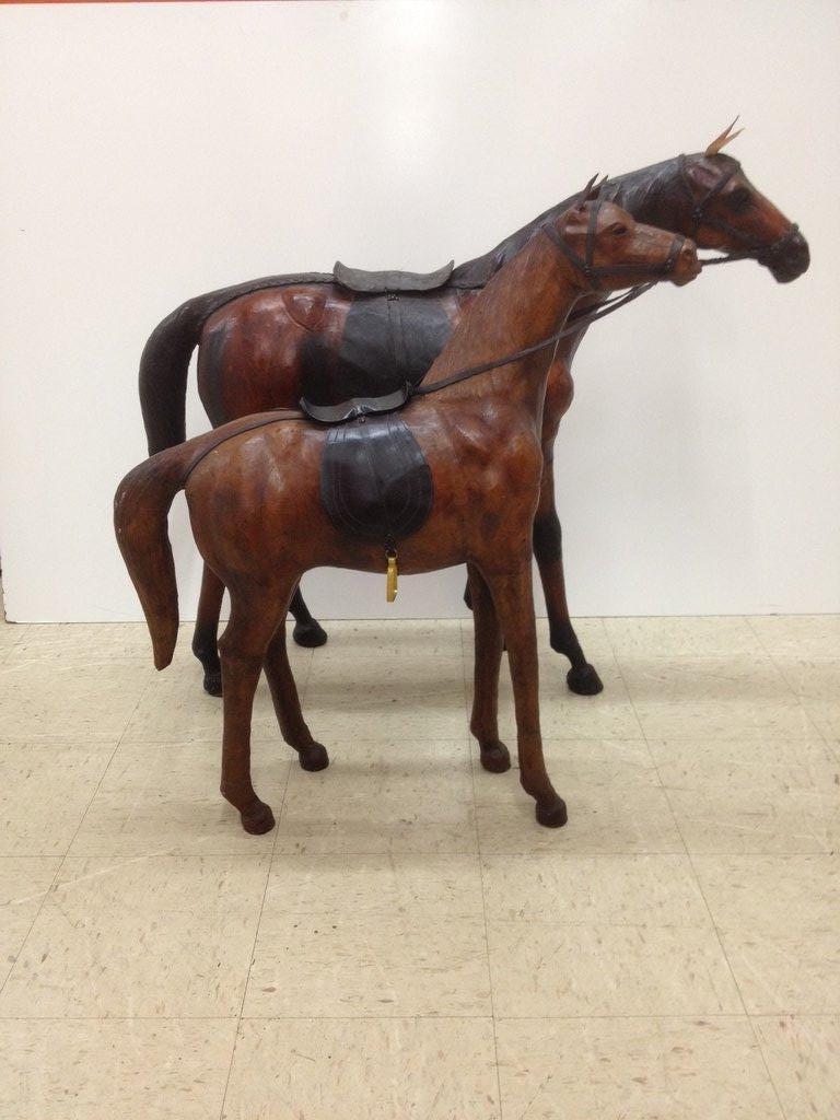 Abercrombie and Fitch single, pair or three leather sculpture horses representative of a Mare and a Stallion, with beautiful glass eyes, and realistic details, available individually for the large horse at $1875 and the smaller at $1600 each.