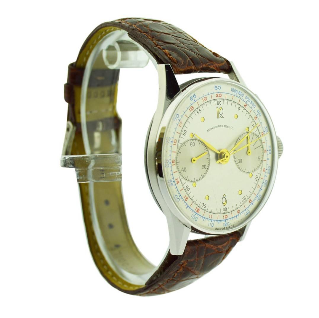 FACTORY / HOUSE: Abercrombie and Fitch
STYLE / REFERENCE: Art Deco / Chronograph
METAL / MATERIAL: Stainless Steel
CIRCA: 1940
DIMENSIONS: 45mm X 36mm
MOVEMENT / CALIBER: Manual Winding /  17 Jewels 
DIAL / HANDS: Silvered with Gold Numerals / Gilt