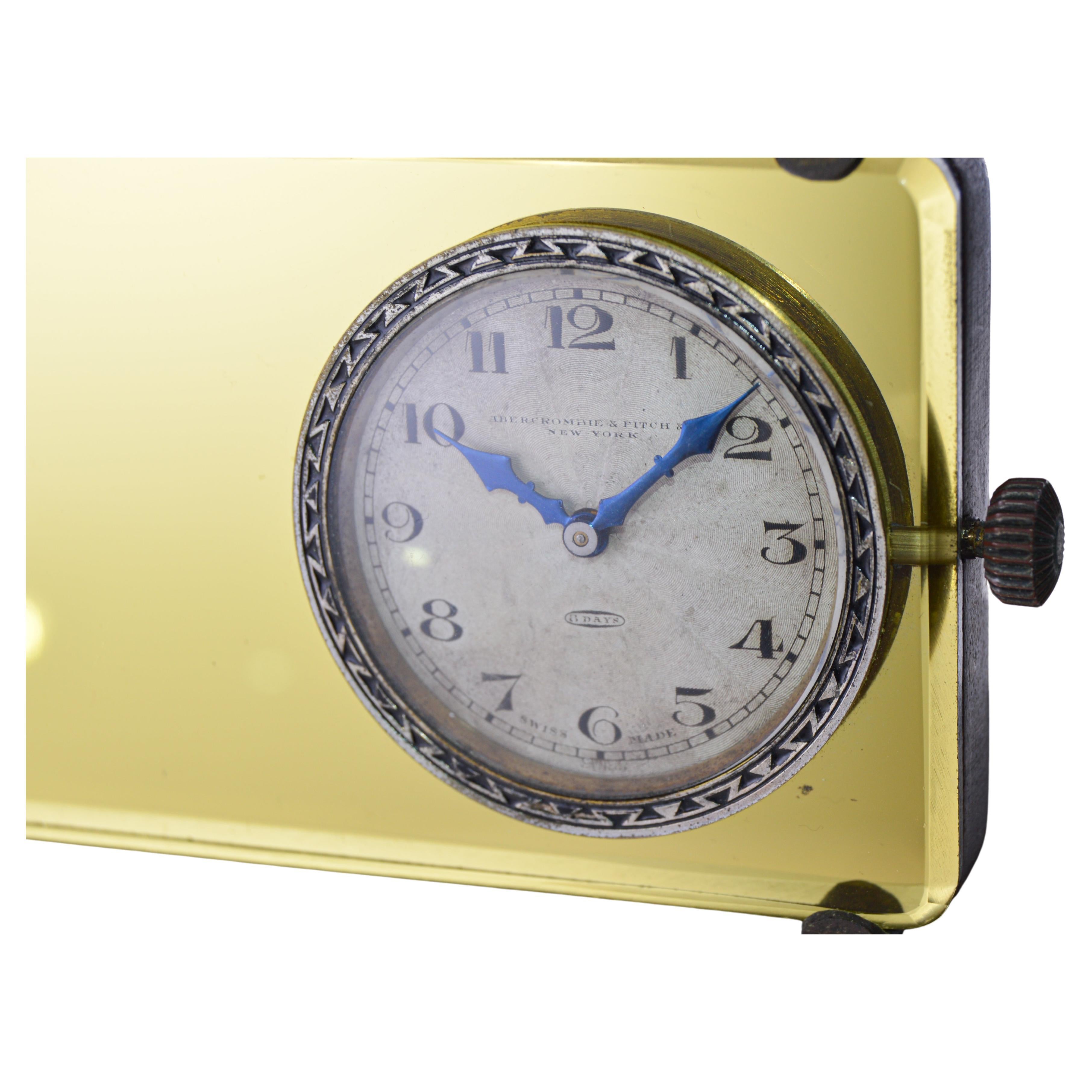 FACTORY / HOUSE: Abercrombie & Fitch
STYLE / REFERENCE: Rear View Mirror Desk Clock 
METAL / MATERIAL: Wood, Metal and Glass 
CIRCA / YEAR: 1930's
DIMENSIONS: 6 Inches Long X 3 Inches Tall X 2 Inches deep
MOVEMENT / CALIBER: Swiss 8 Day Clock 15