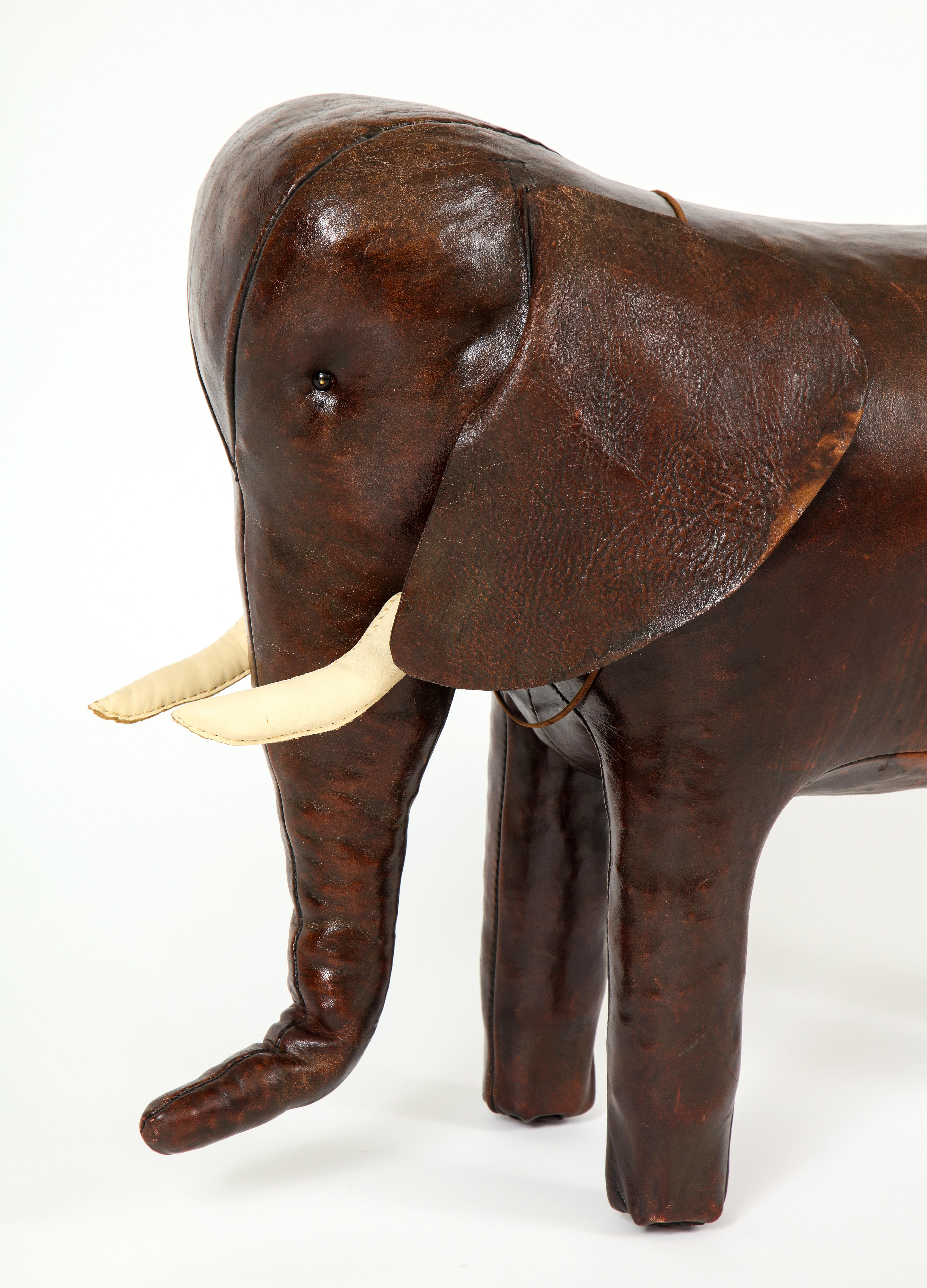 Fun and whimsical is this large leather elephant designed by Dimitri Omersa for Abercrombie & Fitch. Beautiful condition with some striation on one side of his body which gives him character and personality. Acquired from a family's personal