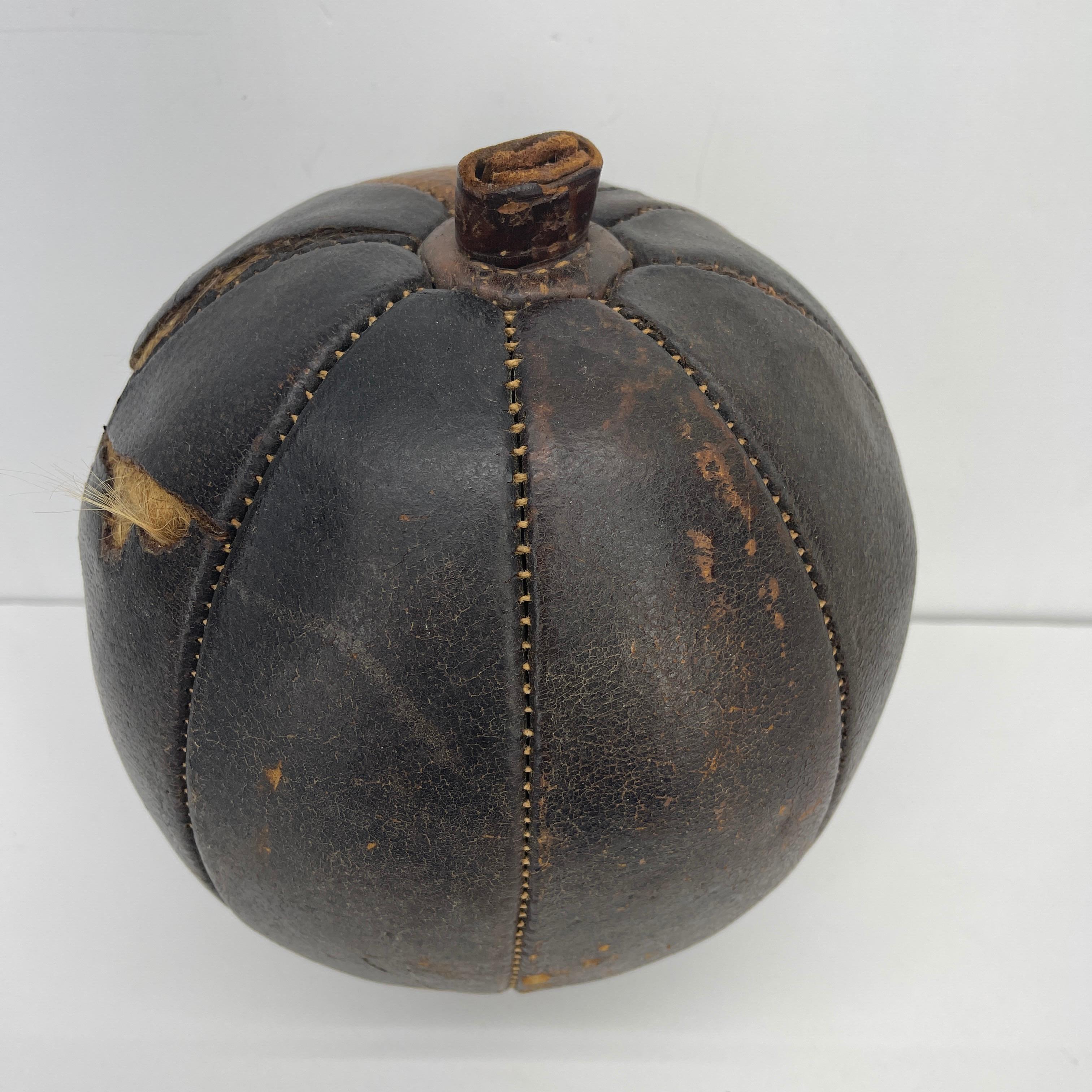 Mid-Century Modern Abercrombie & Fitch hand-stitched leather pumpkin by Omersa & Company. The wide selection of leather items designed by Dimitri Omersa were used for display and footstools at the Abercrombie and Fitch stores in England in the