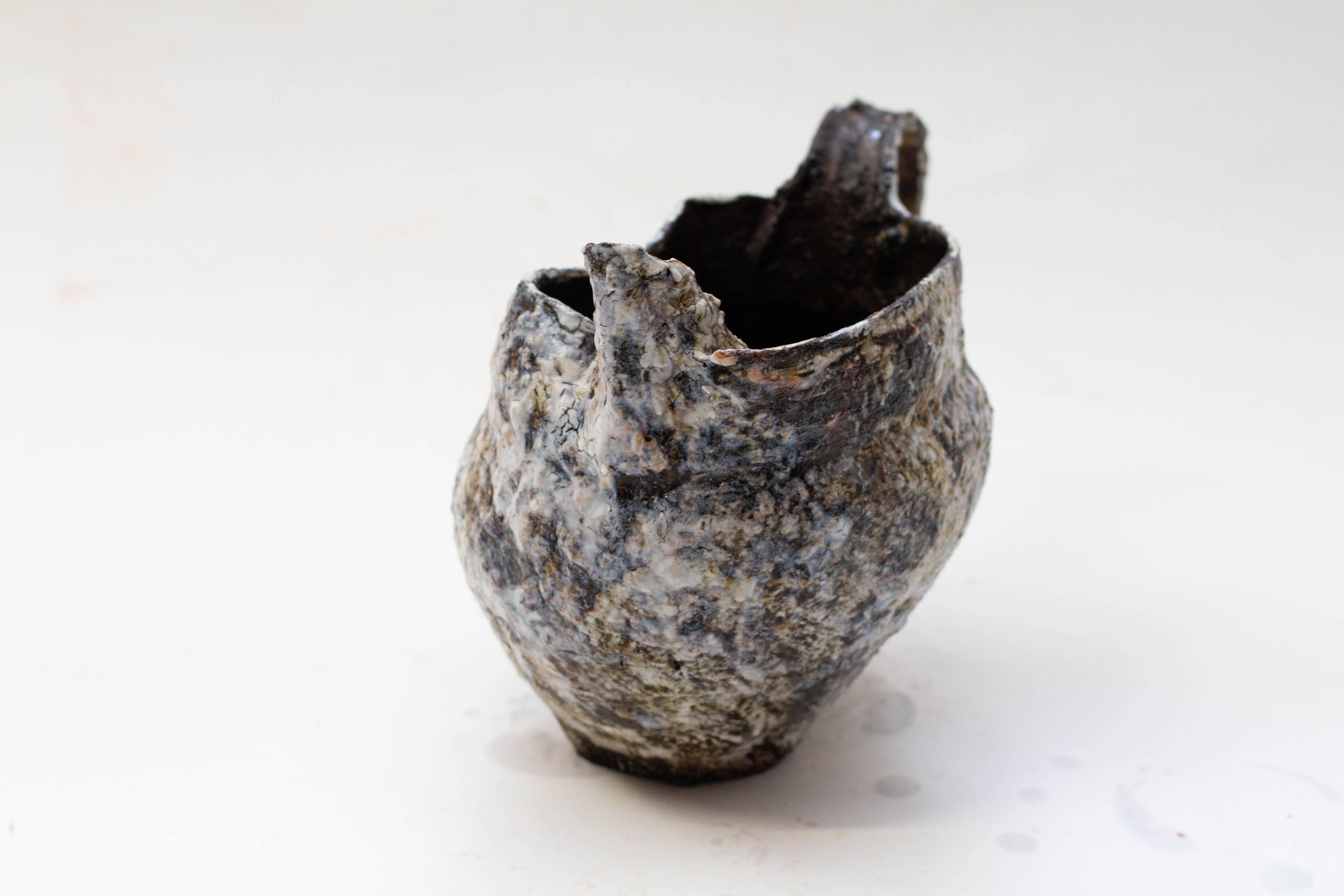 Made of a chunky black clay, washed with porcelain, and glazed with various white glazes together with beech ash. The process and alchemic reaction gives moments of naturally occurring pinks and blue, with what appears like a rusty patina on the