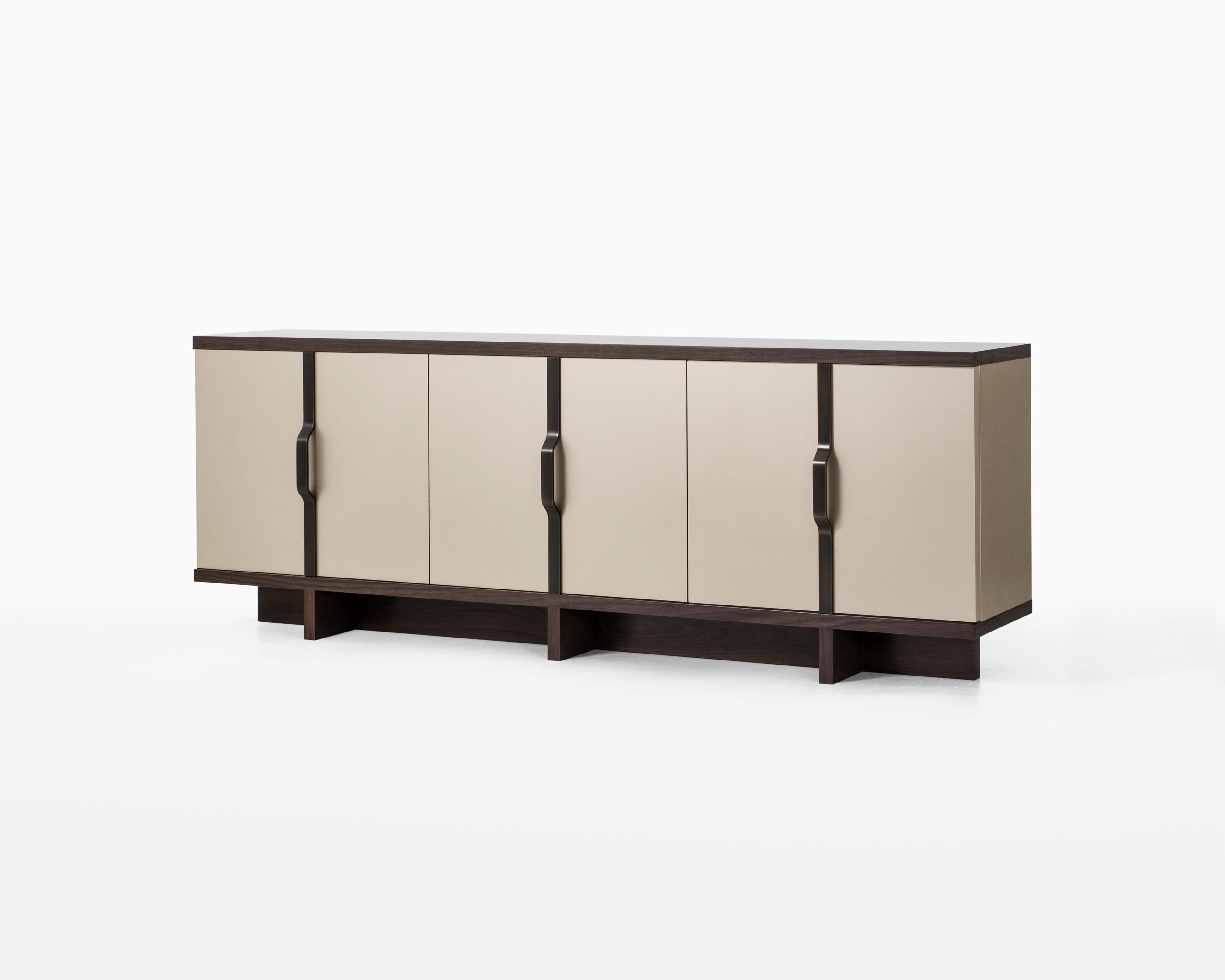 Lacquer, wood and metal offer personalized combinations in this versatile storage cabinet. Multi-layer lacquer finish covers the six doors and sides as well as the complete interior space, while hand-applied walnut finish on the top and base detail