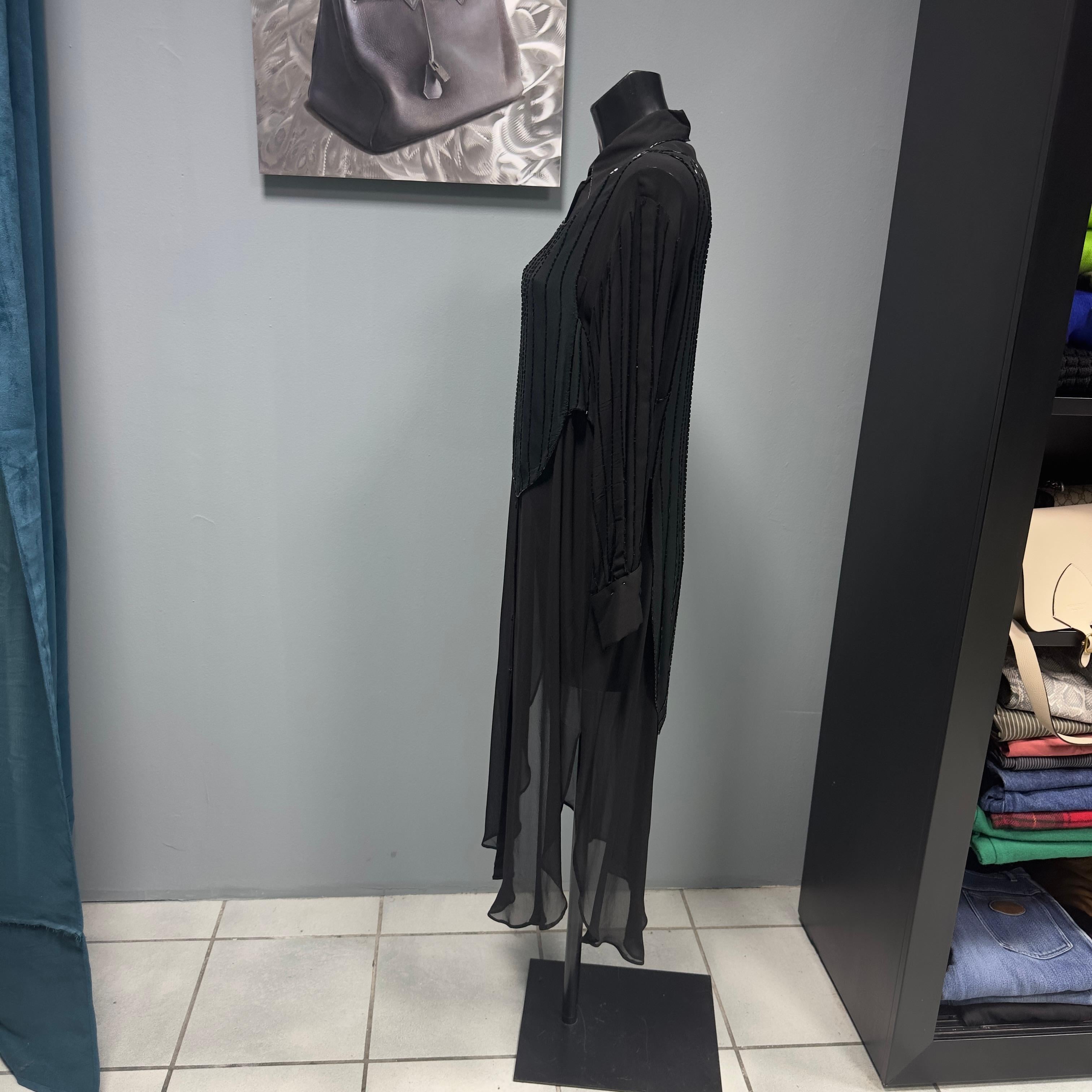 Ferretti studio dress composed of 2 pieces
Transparent black long shirt with breast pocket and black sequins on sleeves and collar edge 
To complete black vest with tone-on-tone sequins that echo those on the shirt 
As pictured some are missing but
