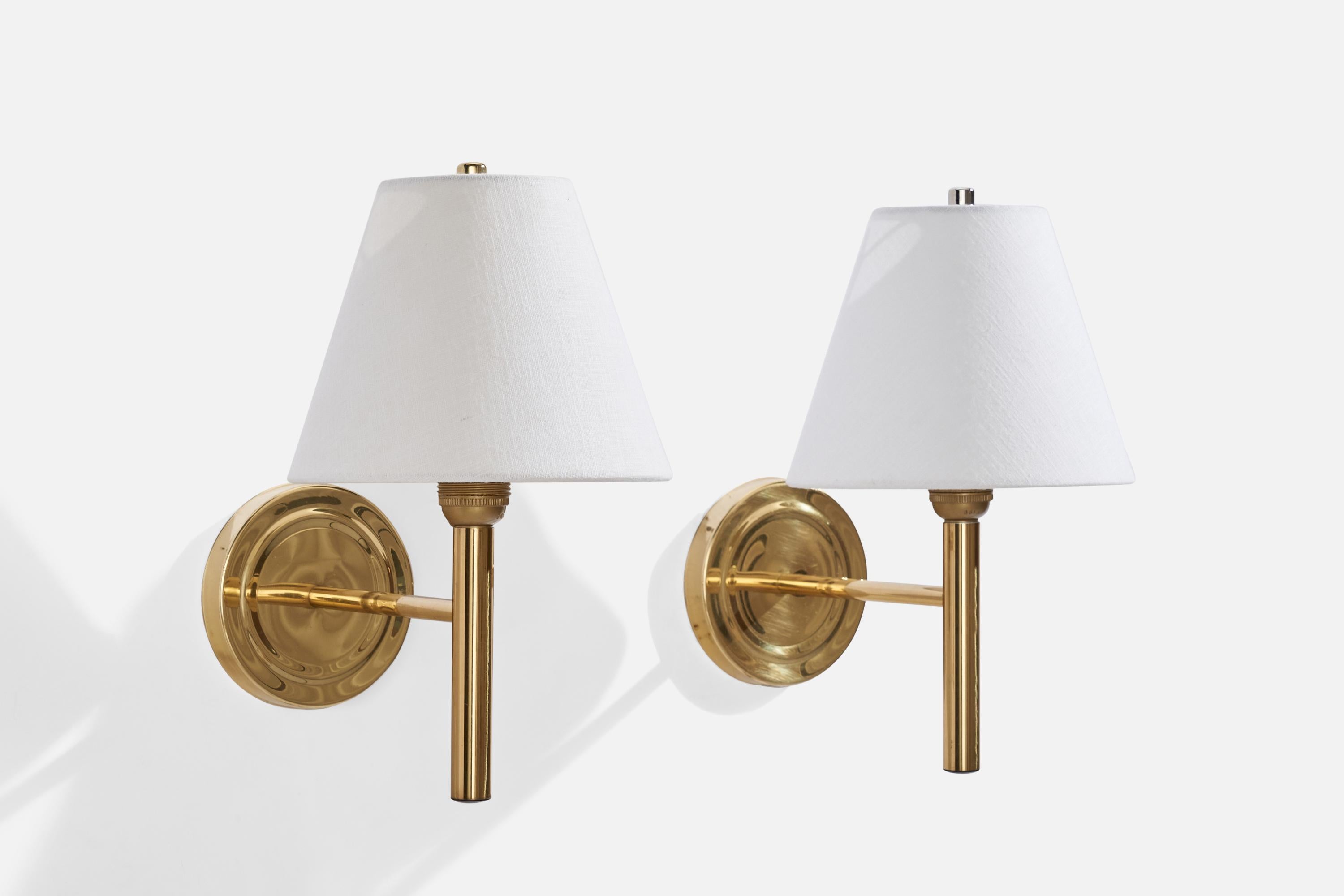 A pair of brass and white fabric wall light produced by Abo Randers, Denmark, c. 1970s.

Overall Dimensions (inches): 13” H x 8” W x 11” D
Back Plate Dimensions (inches): 5.14” H x 0.75” D
Bulb Specifications: E-26 Bulb
Number of Sockets: 2
All