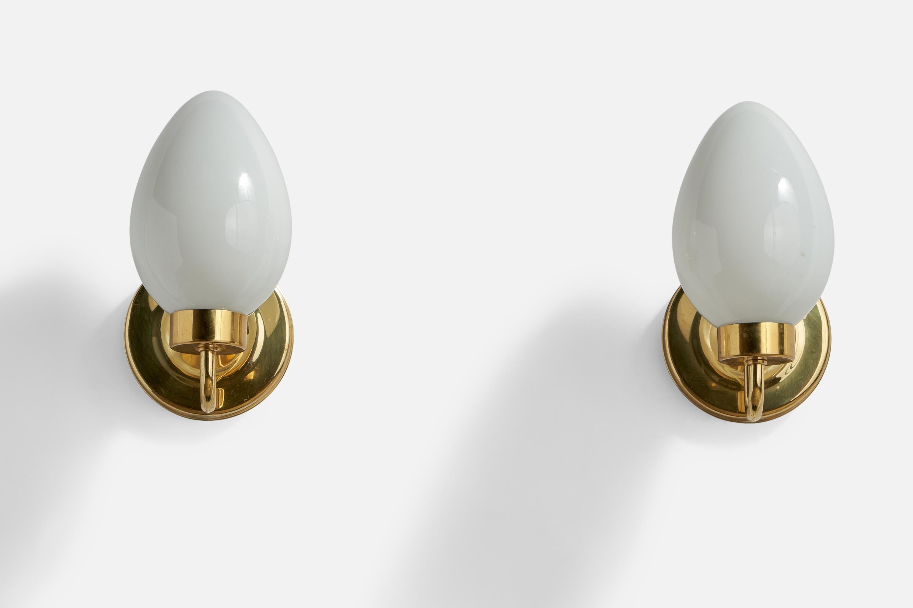A pair of brass and opaline glass wall lights designed and produced by Abo Randers, Denmark, 1970s.

Overall Dimensions (inches): 8.5” H x 4.3” W x 6” D
Back Plate Dimensions (inches): 4.3” Diameter x 0.65” Depth
Bulb Specifications: E-14
