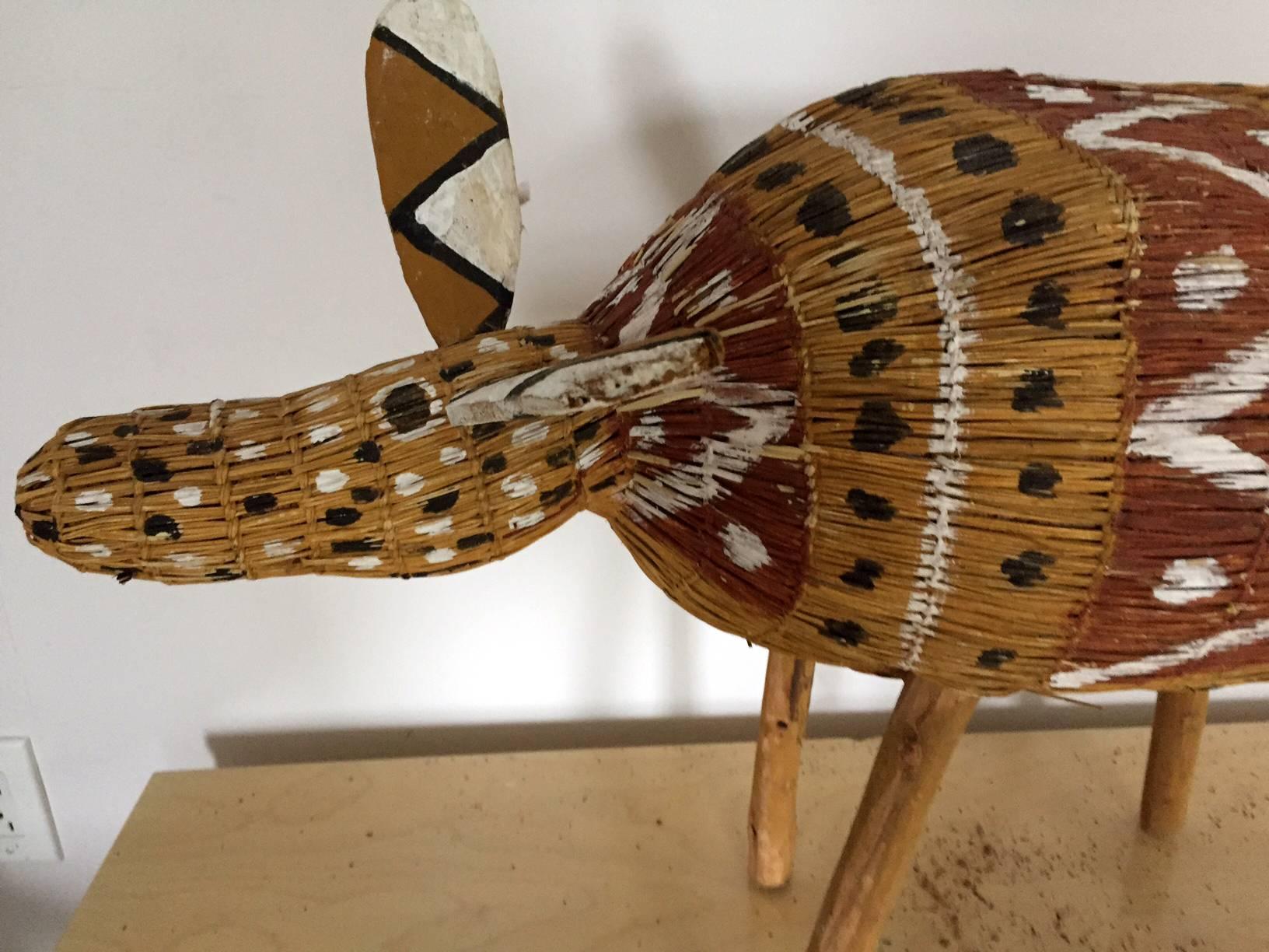 Aboriginal fiber art camp dog, known as Jamu.
Artist: Yolanda Rostron.
Year of birth: 1979.
Nationality: Australian.
Region: South Central Arnhem Land.
Language group: Rembarrnga.
Medium: Pandanus fiber with ocher paint.
Measurement: 112 x 27