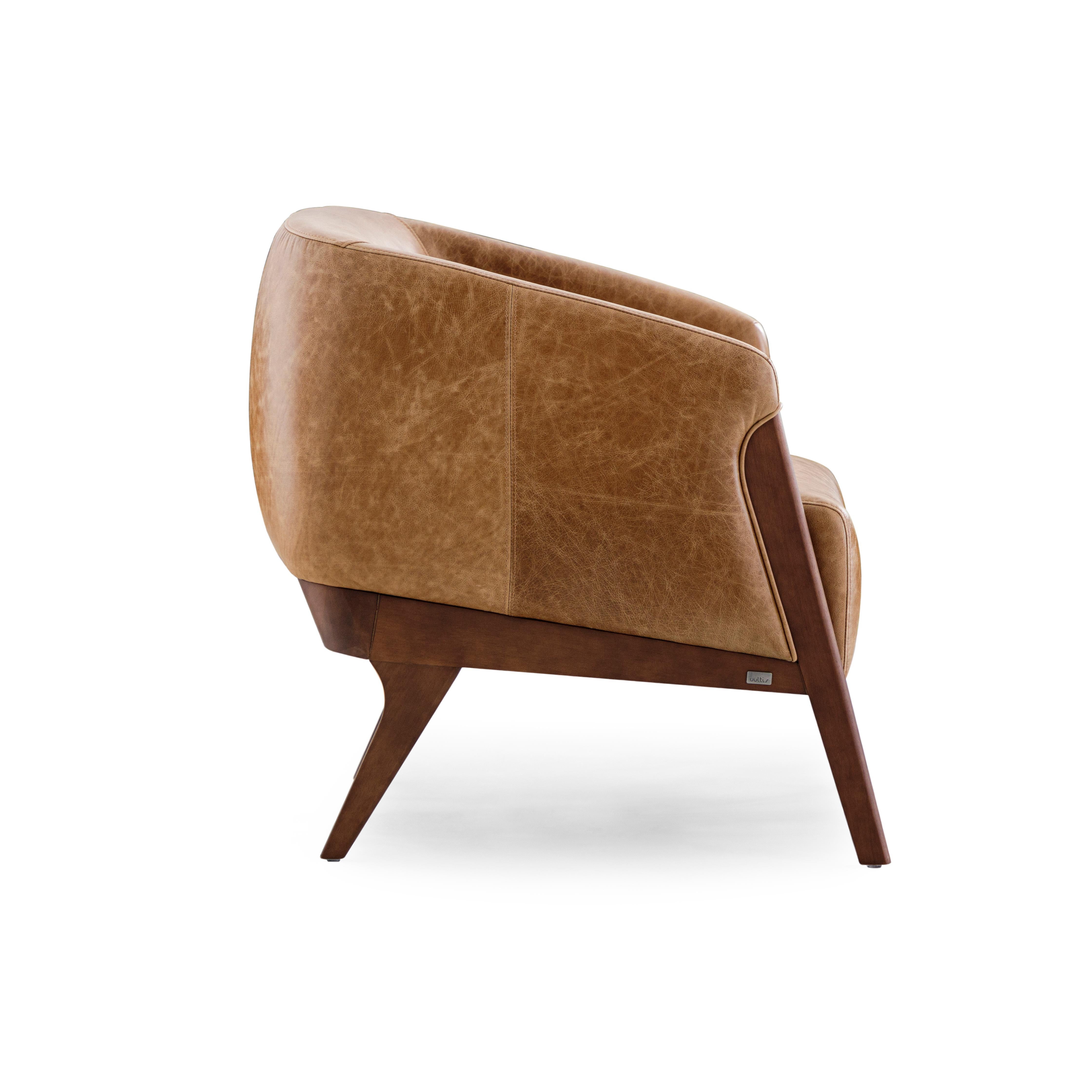 The Abra armchair is a welcoming addition to any room in your decor, with beautiful brown leather upholstery and a walnut wood frame. This armchair has been created by our amazing team of architectors and designers from Uultis in order to bring
