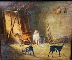 19th century English interior barn scene with a family of goats and baby goats.
