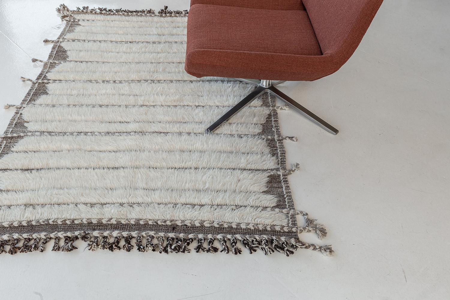 Abrolhos is a handwoven luxurious wool rug with timeless embossed detailing. In addition to its perfect ivory flat-weave, Albrohos has a beautiful shag that brings a lustrous texture and contemporary feel to one's space. The Haute Bohemian