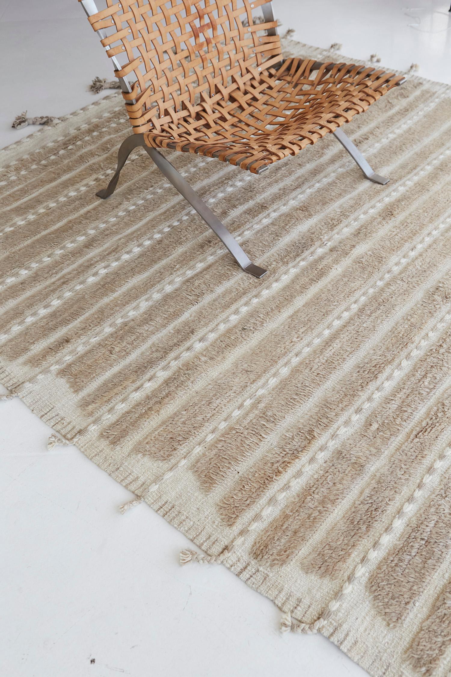 Abrolhos is a handwoven luxurious wool rug with timeless embossed detailing. In addition to its muted brown flatweave, Albrohos has a beautiful shag that brings a lustrous texture and contemporary feel to one's space. The Haute Bohemian collection