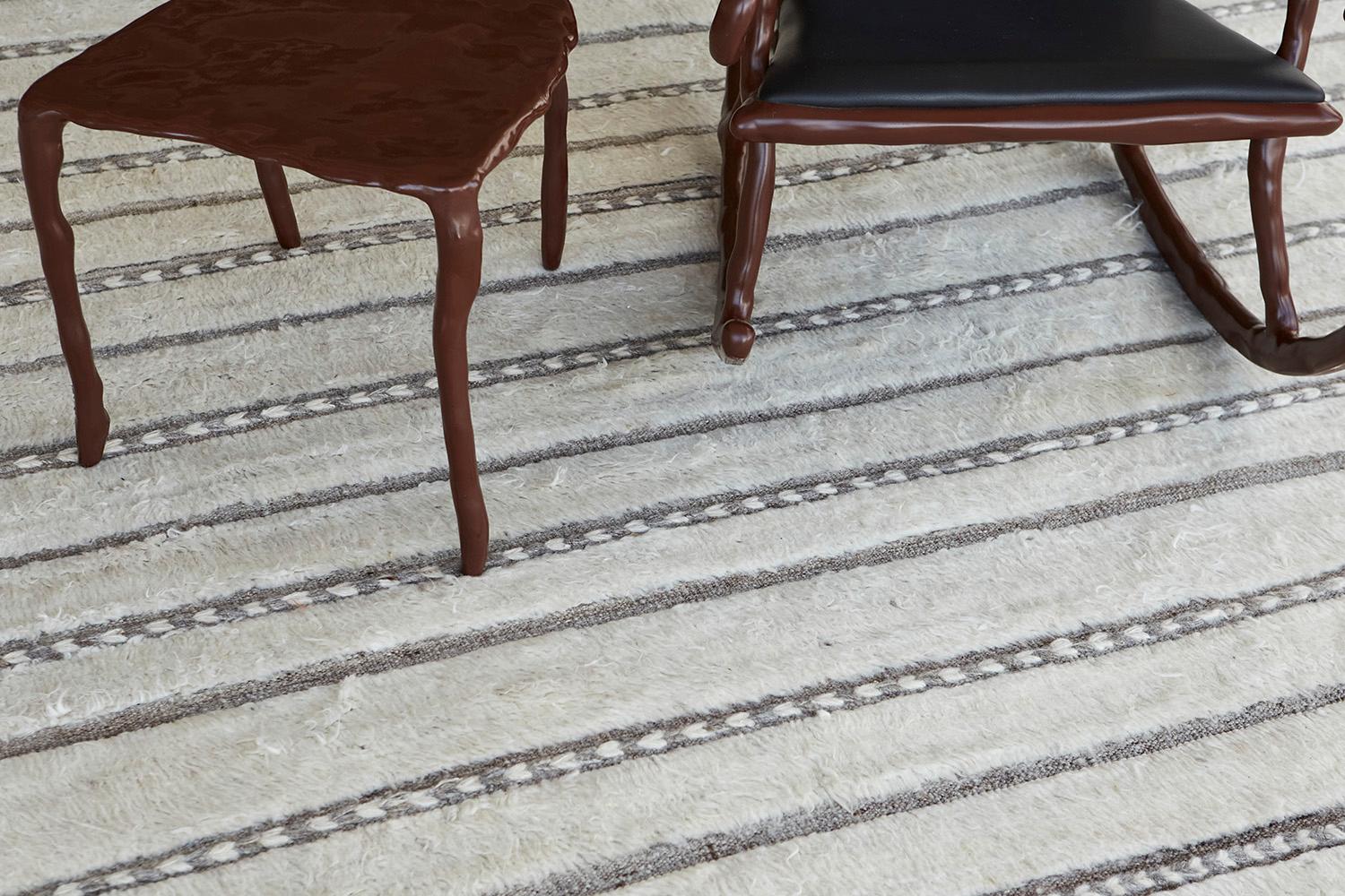 Abrolhos' is a handwoven luxurious wool rug with timeless embossed detailing. In addition to its perfect ivory flat weave, Albrohos has a beautiful shag that brings a lustrous texture and contemporary feel to one's space. The Haute Bohemian