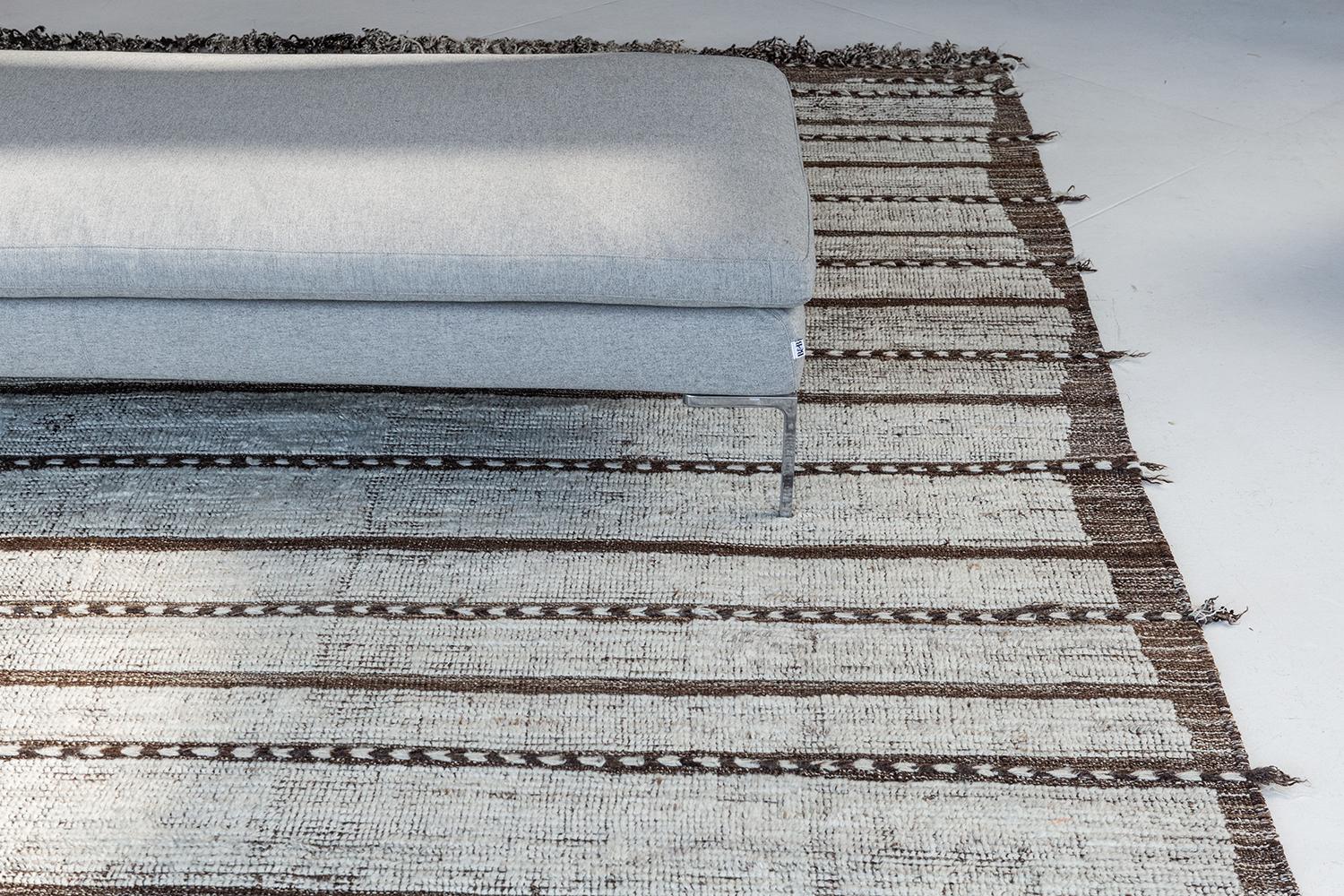 Abrolhos is a handwoven luxurious wool rug with timeless embossed detailing. In addition to its perfect ivory flat weave, Albrohos has a beautiful shag that brings a lustrous texture and contemporary feel to one's space. The Haute Bohemian