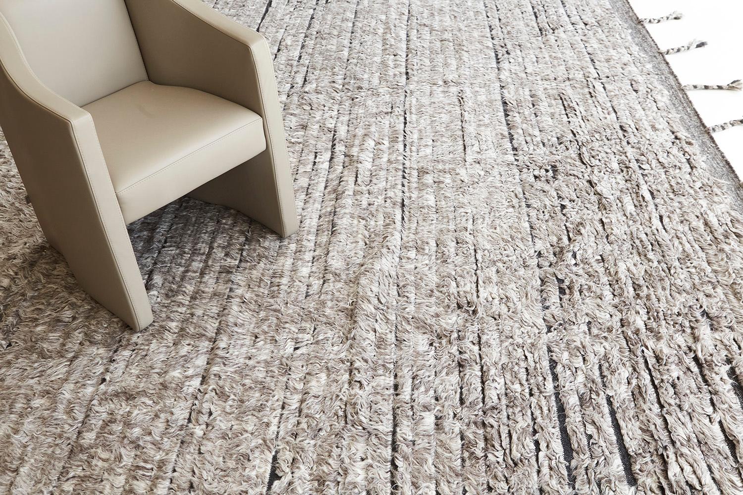 Abroshca is a handwoven luxurious wool rug with timeless embossed detailing. In addition to its perfect grayscaled flatweave, Abroshca has a beautiful shag that brings a lustrous texture and contemporary feel to one's space. The Haute Bohemian